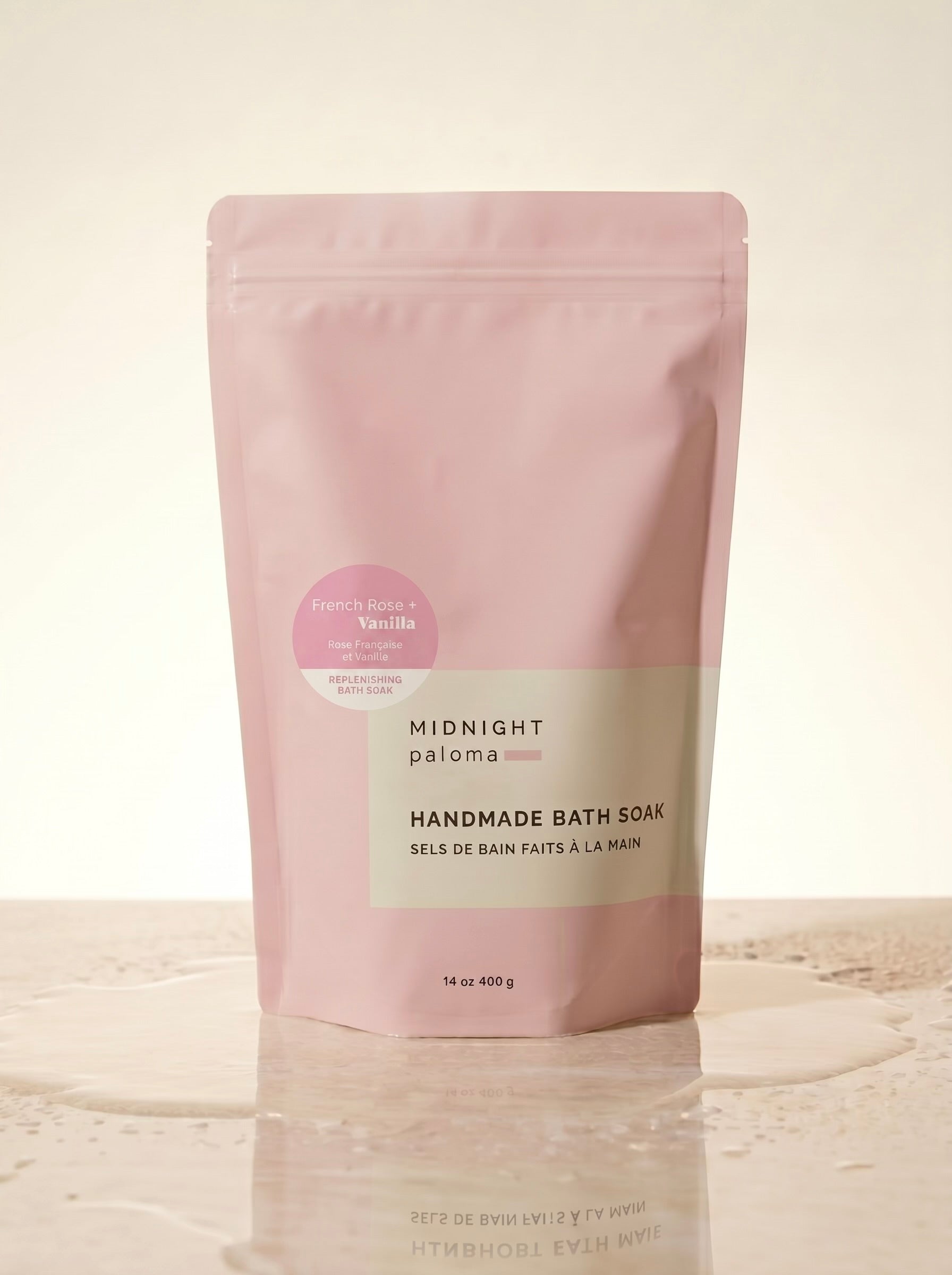 Pink packaging of handmade bath soak on a beige background