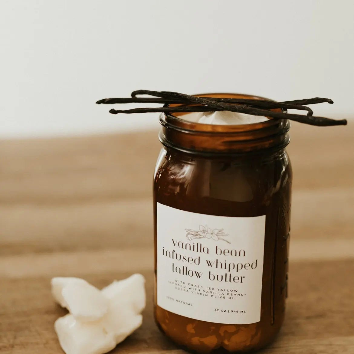 Vanilla bean infused whipped butter in an amber jar on a wooden surface