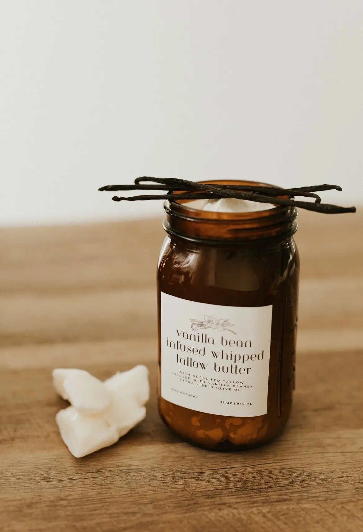 Vanilla bean infused whipped butter in an amber jar on a wooden surface