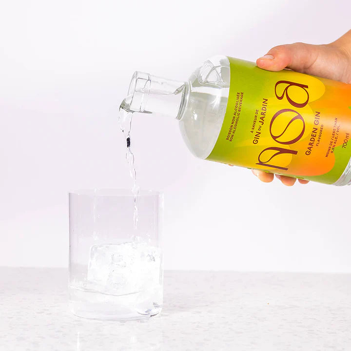 Bottle of Bosa non-alcohol Gin being poured into a glass on a white background The Sobr Market