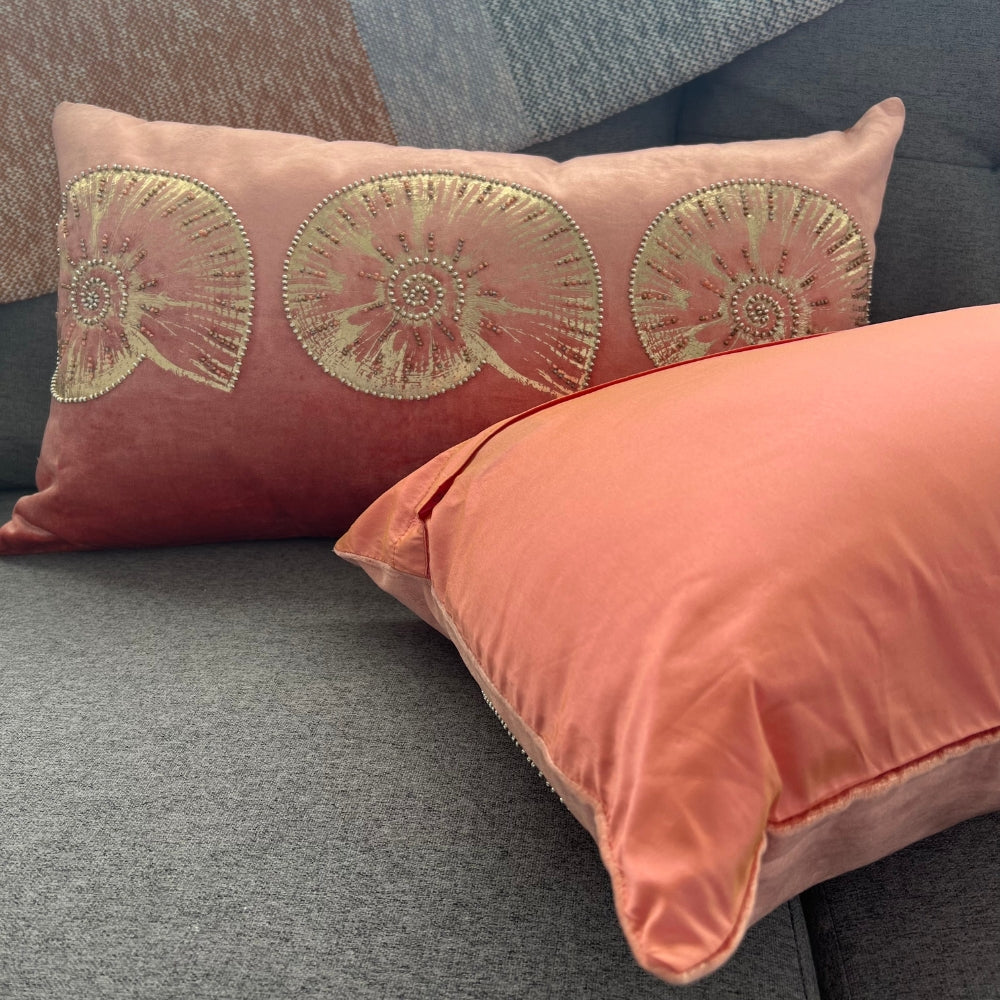 Decorative pillows with floral embroidery on a gray sofa