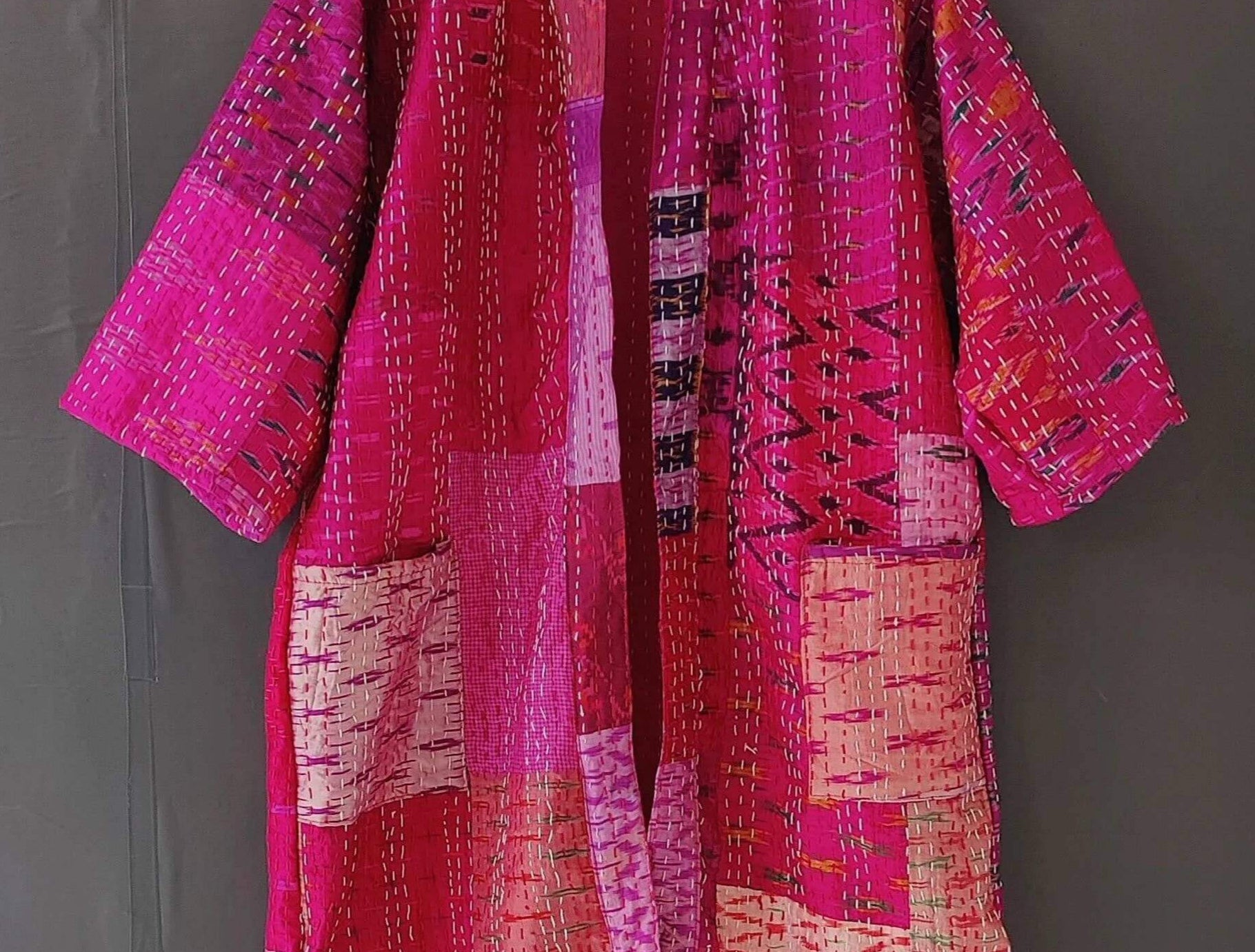 Handmade Kantha quilted kimono bathrobe in vibrant pink hues, made from organic cotton and perfect for layering.