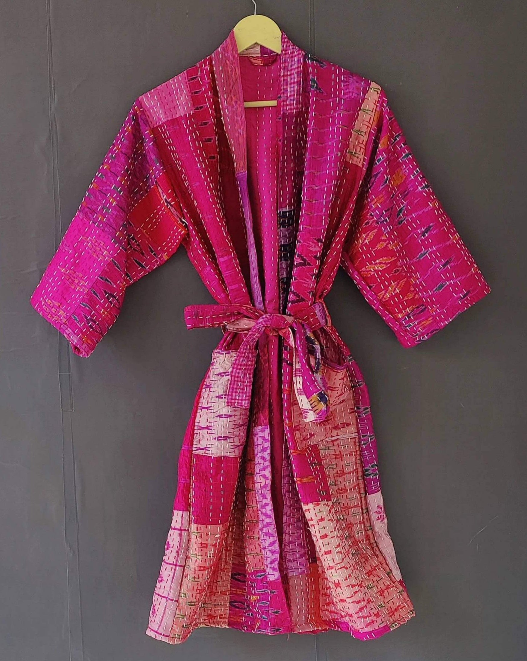 Handmade silk quilted kimono jacket in vibrant pink, perfect as a beach cover-up or robe, featuring a matching belt.