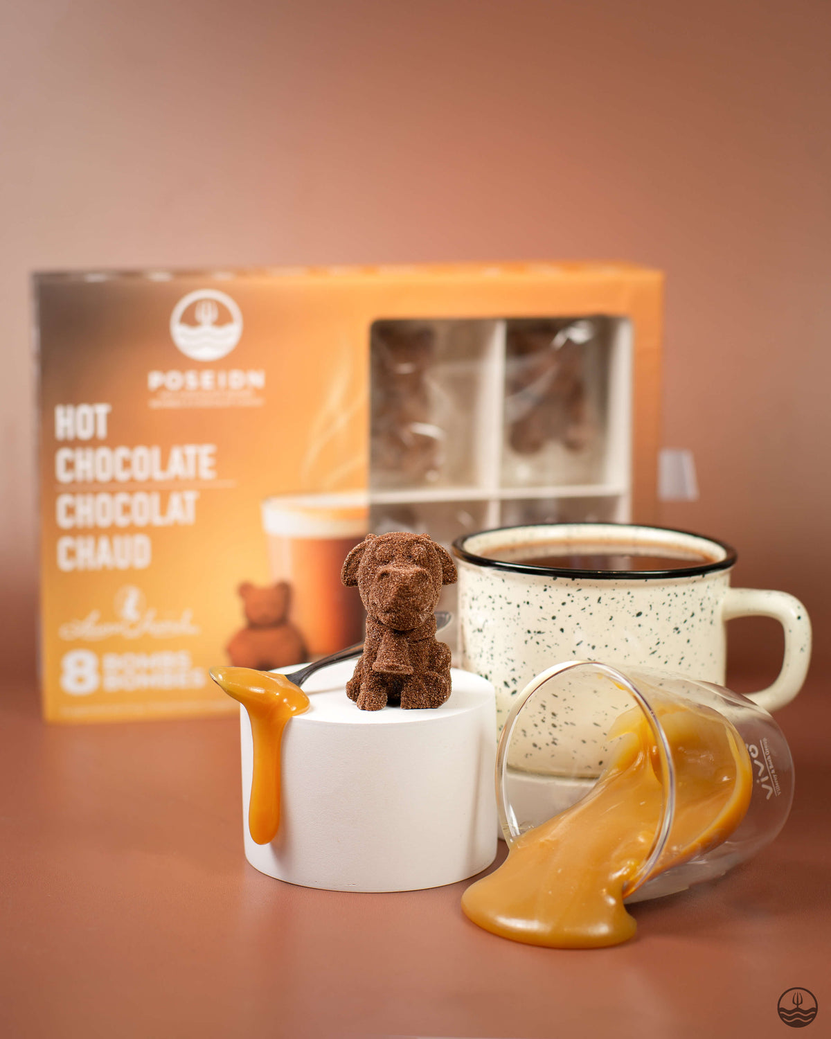 Hot chocolate set with a mug, box, and small dog-shaped container on a brown background
