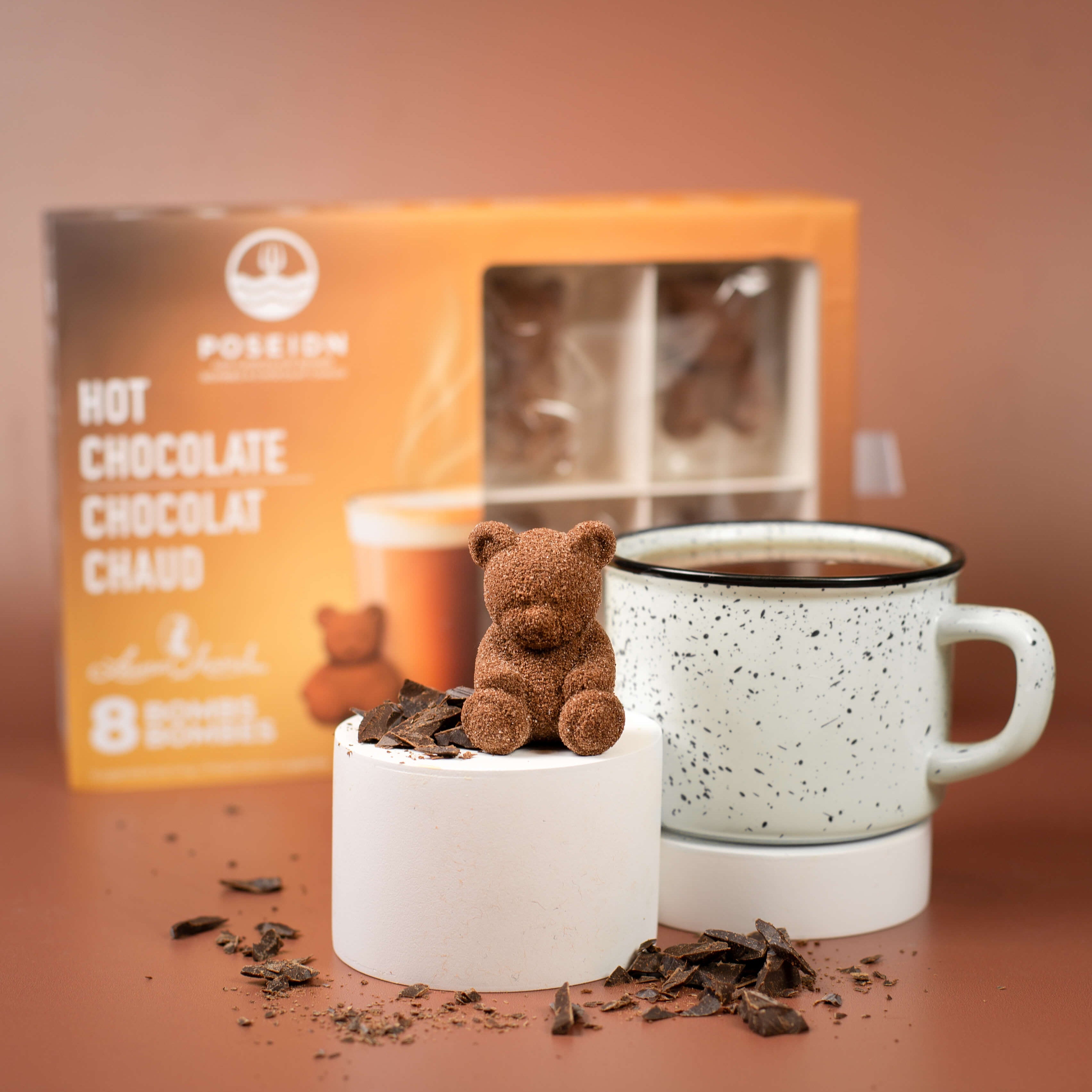 Hot chocolate with a teddy bear and packaging on a brown background