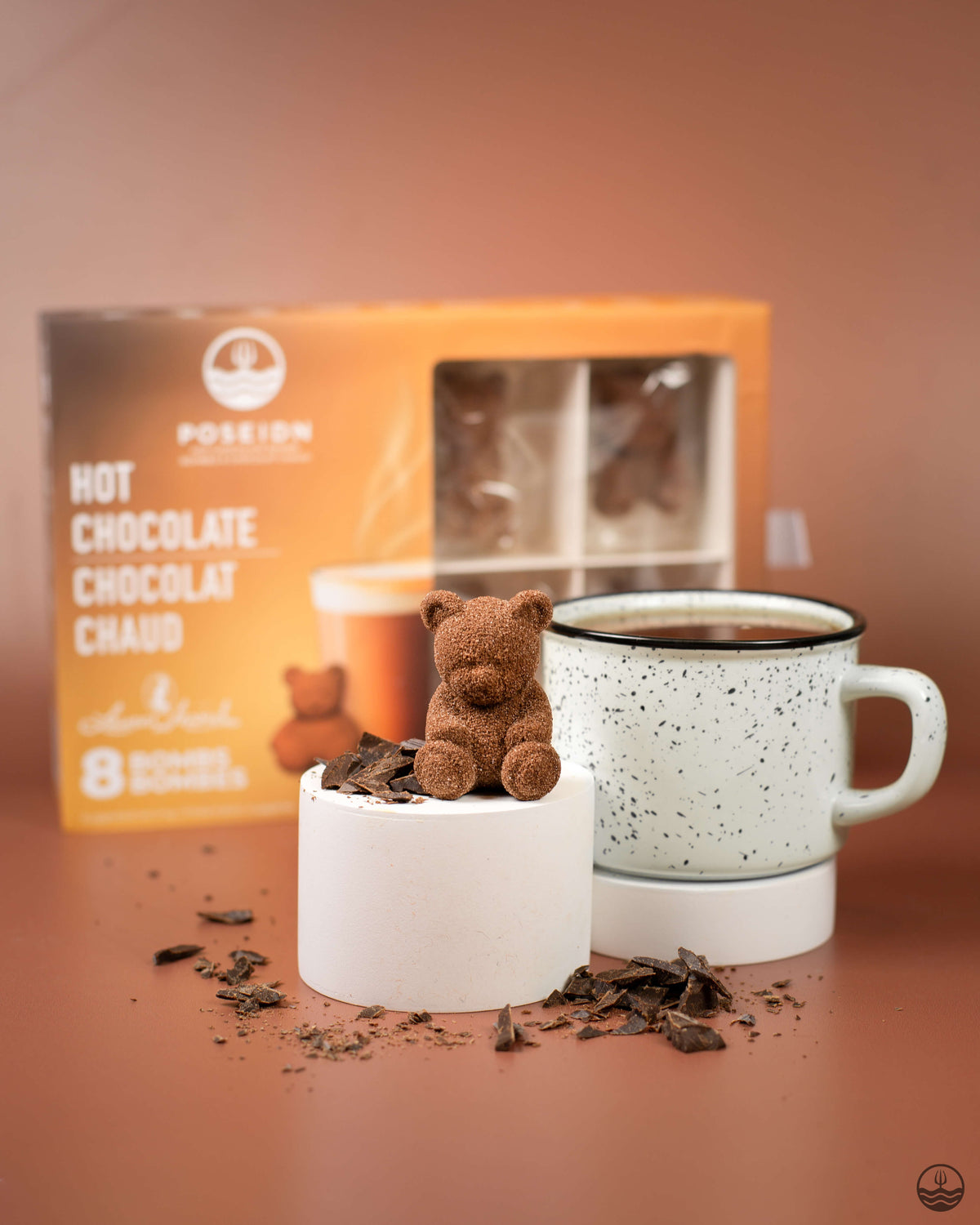 Hot chocolate with a teddy bear and packaging on a brown background