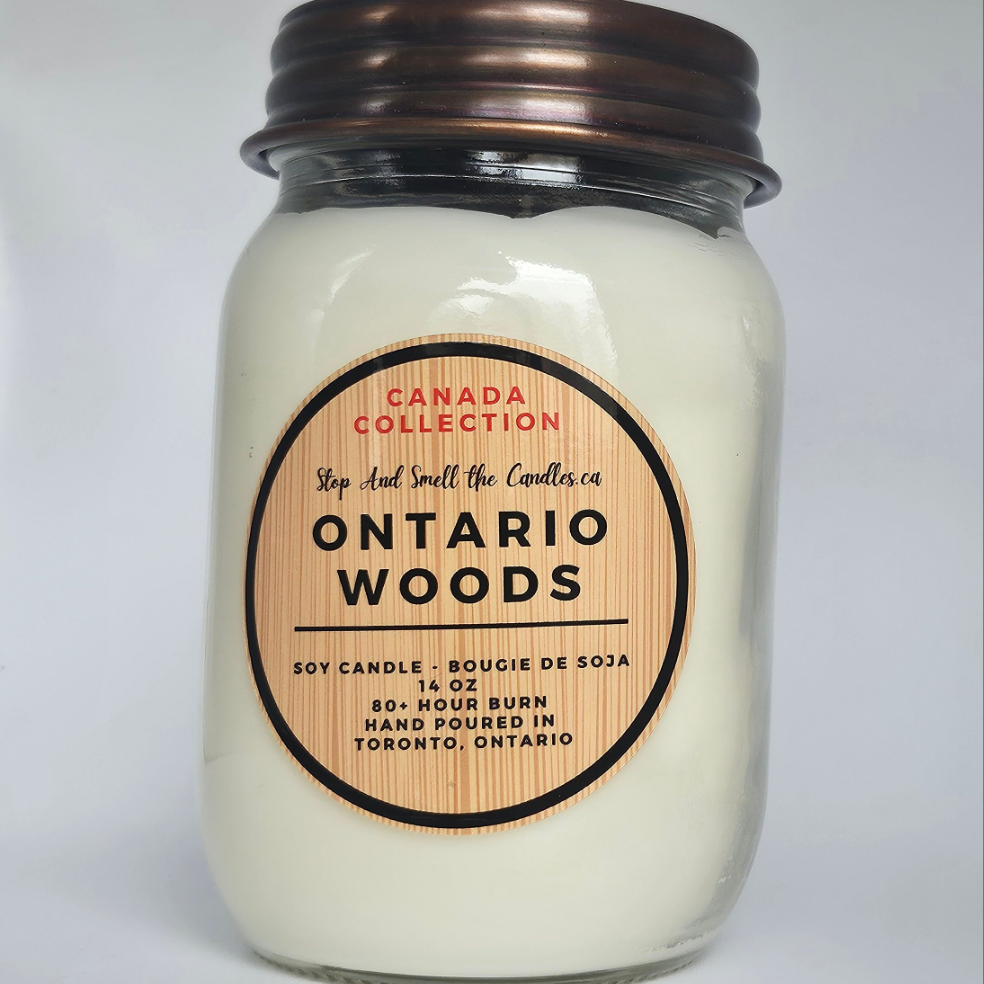 Candle jar labeled 'Ontario Woods' from the Canada Collection on a light gray background