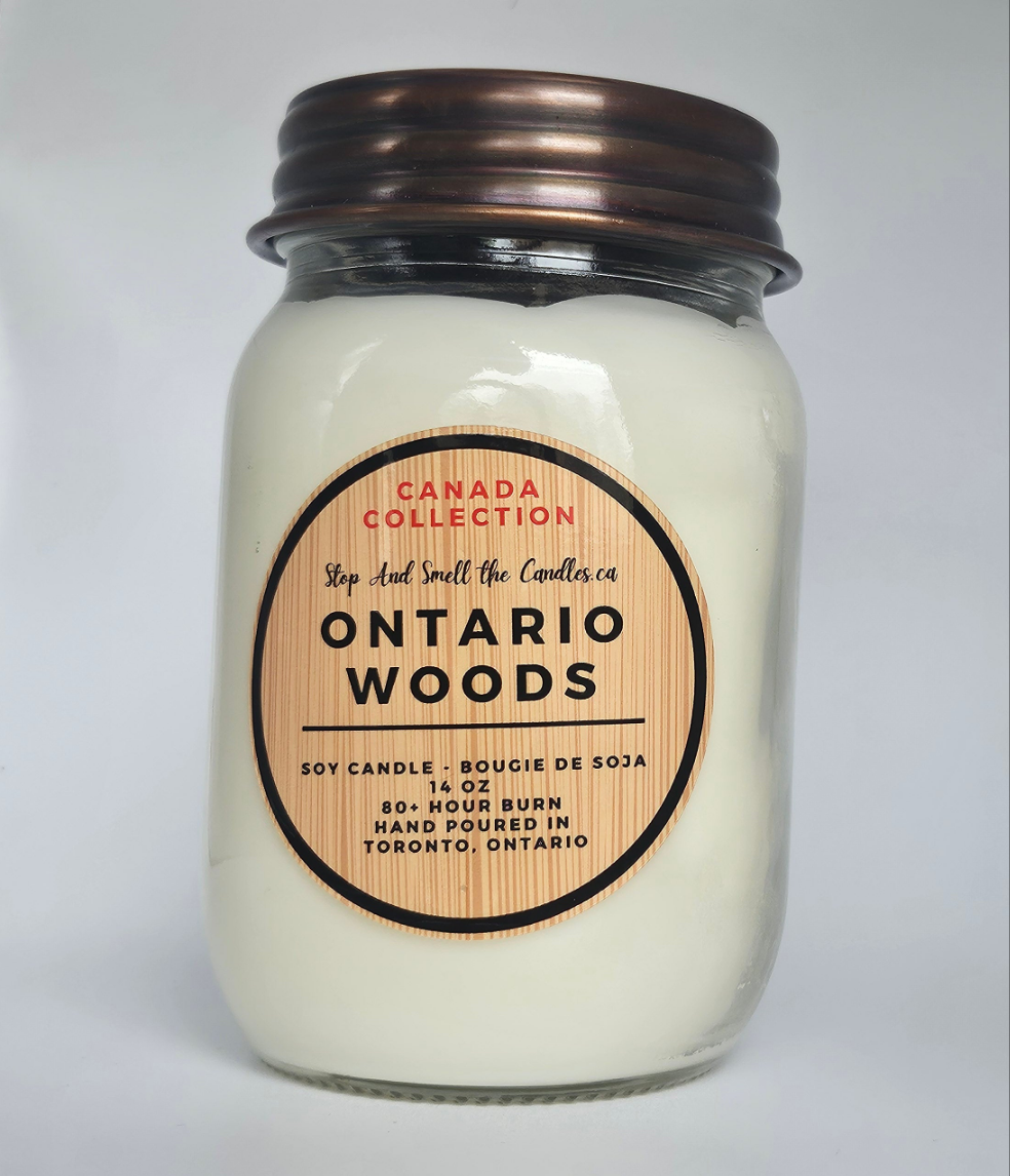 Candle jar labeled 'Ontario Woods' from the Canada Collection on a light gray background