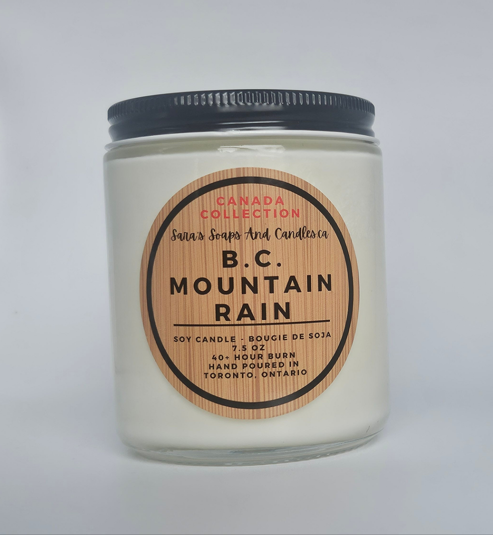 Candle jar labeled 'B.C. Mountain Rain' with a wooden label on a white background