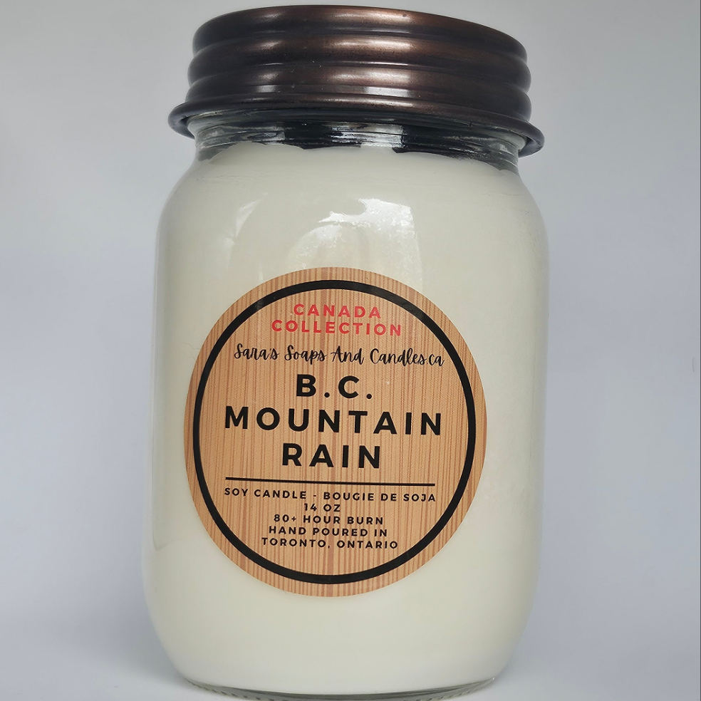 Jar candle labeled 'B.C. Mountain Rain' on a gray background