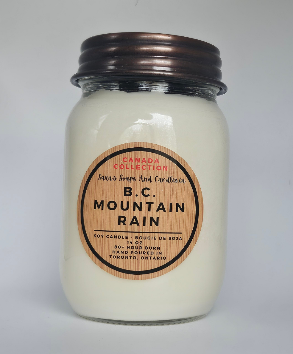 Jar candle labeled 'B.C. Mountain Rain' on a gray background