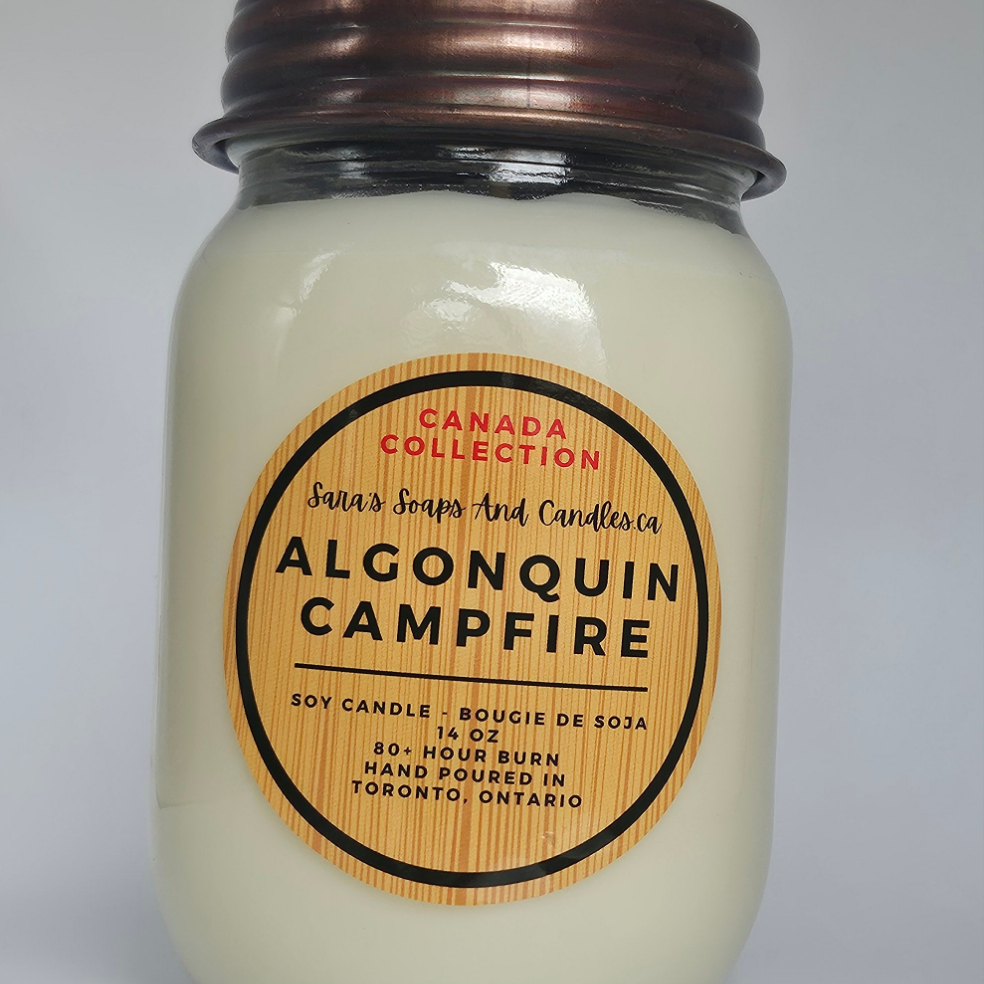 Jar candle labeled 'Algonquin Campfire' from Santa's Soaps and Candles on a white background 