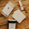 Whipped lather butter product on a wooden surface with branding visible