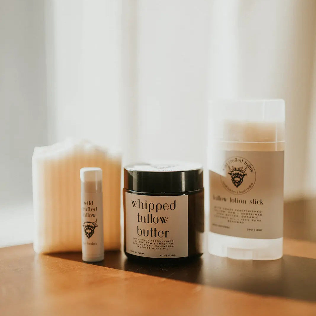 Skincare products including a jar of 'whipped follow butter' on a wooden surface with a soft, blurred background.