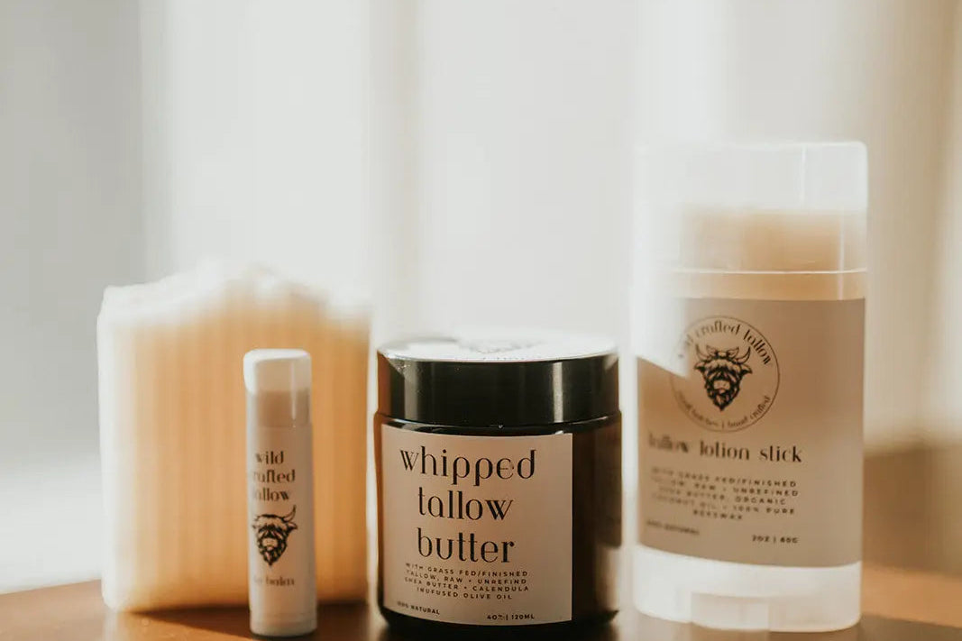 Skincare products including a jar of 'whipped follow butter' on a wooden surface with a soft, blurred background.