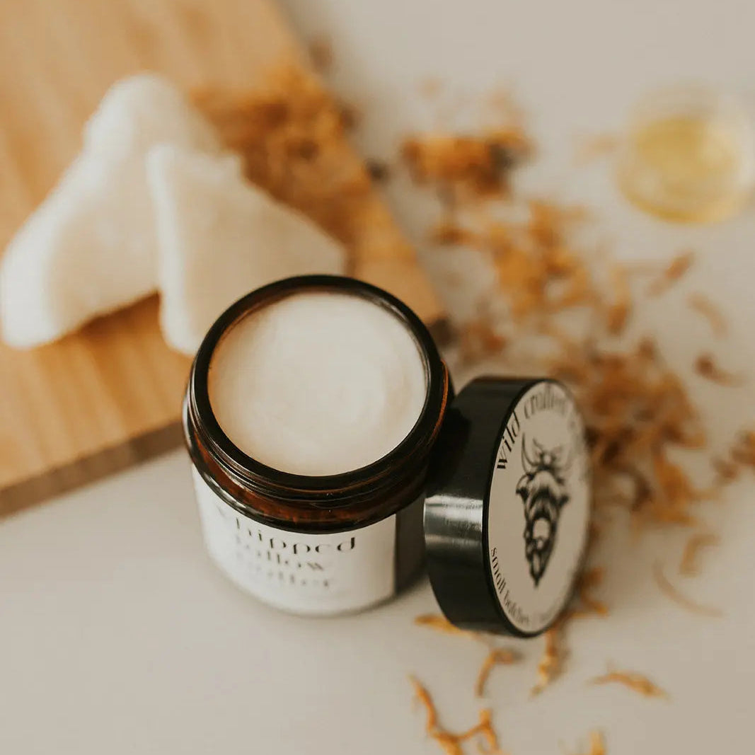 Jar of cream with a lid on a light surface, with a blurred background