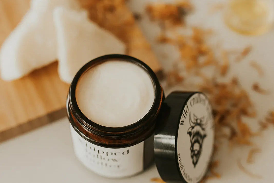 Jar of cream with a lid on a light surface, with a blurred background