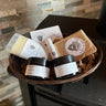 Basket of various skincare products on a stone surface