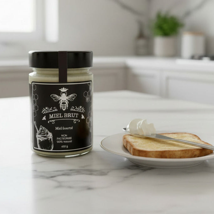 Jar of Miel Brut on a kitchen counter with toast and butter