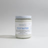 Jar of 'one earth' foot butter on a gray background