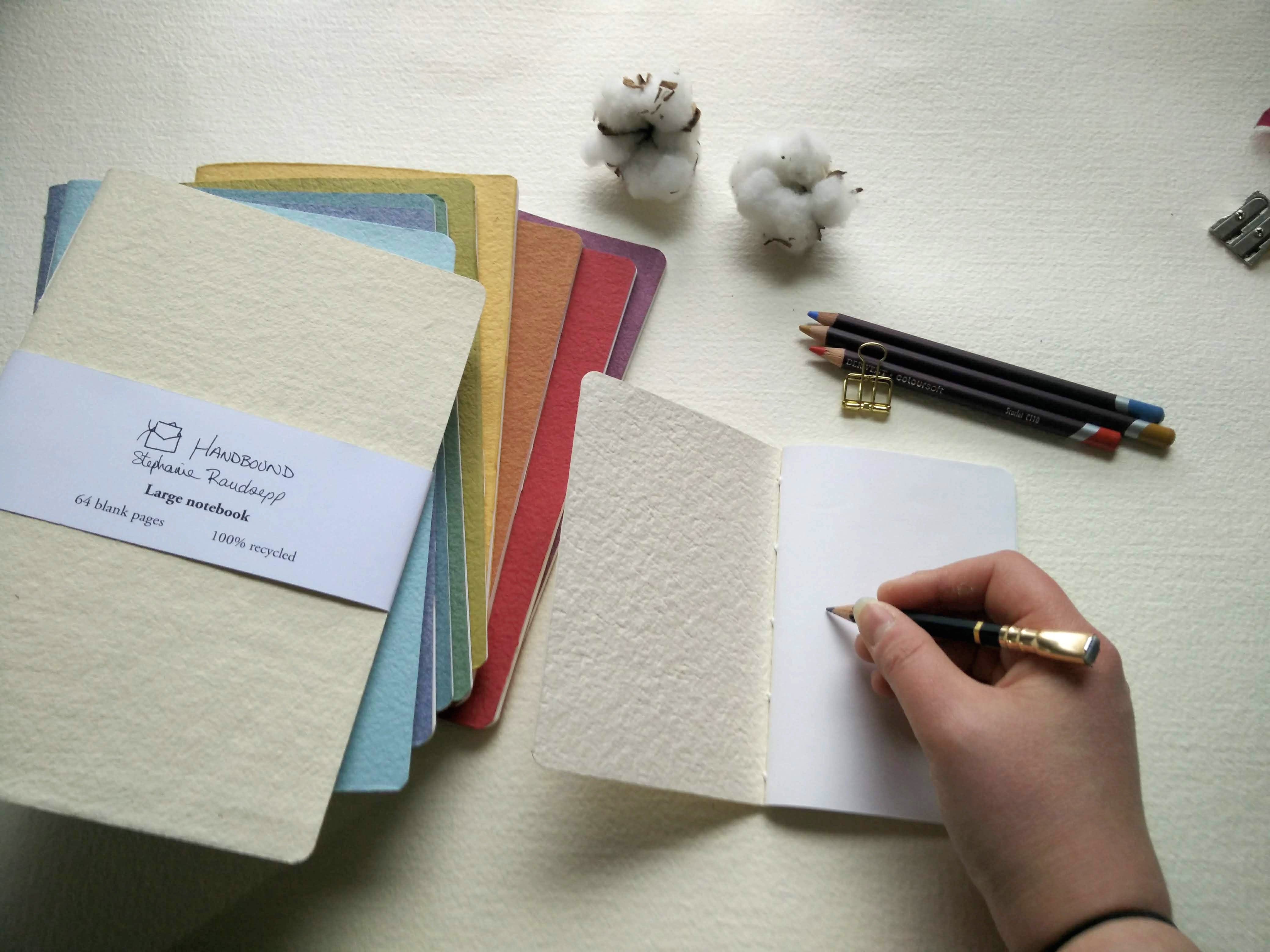 Color swatch book hand stitched plantable paper notebook with string closure on a light grey background Creative Artifacts HQ