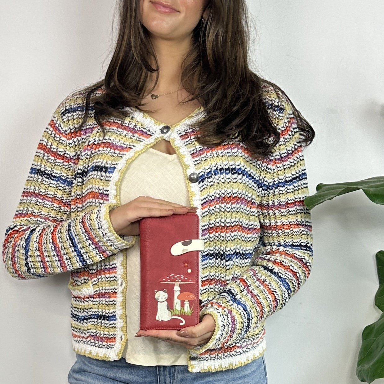 A Espe Vegan Corp red phone pouch with a white cat illustration.