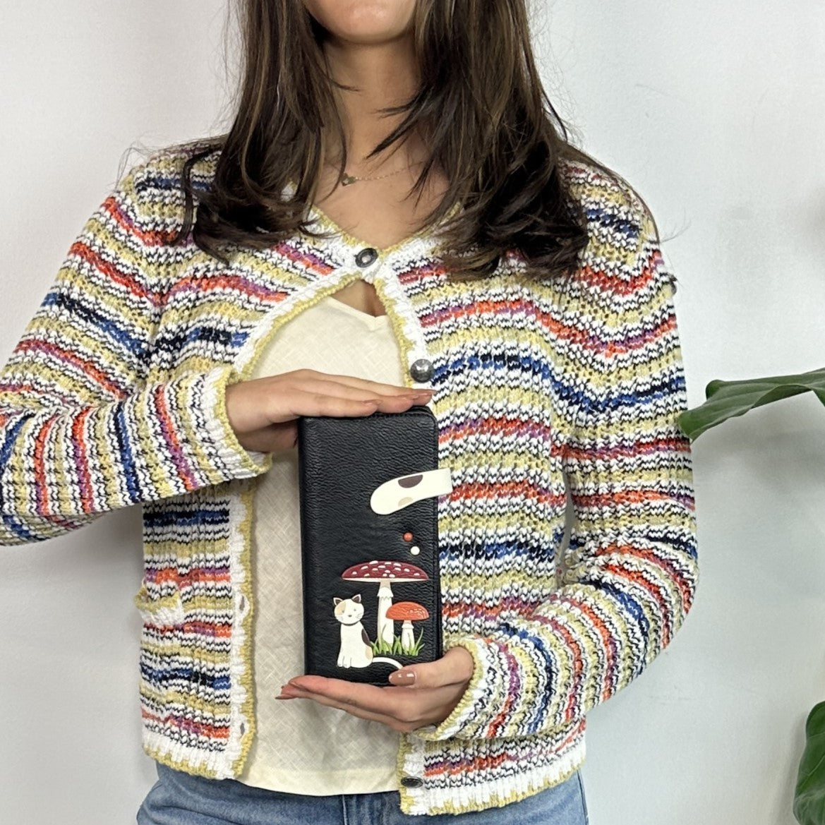 Espe Vegan Corp black clutch bag decorated with a white cat, a red mushroom
