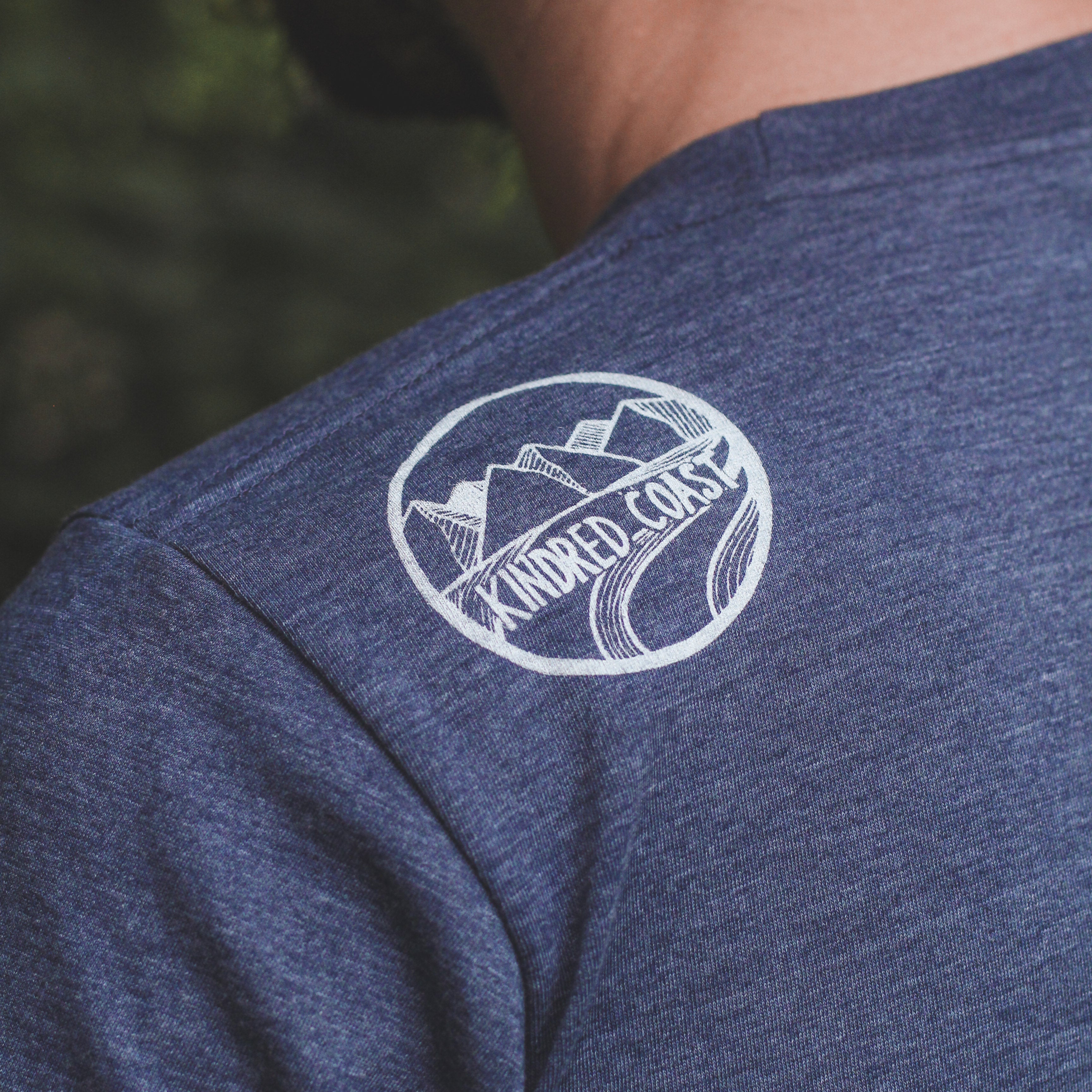 Kindred Coast - RAVEN - Unisex Eco Tee shoulder 