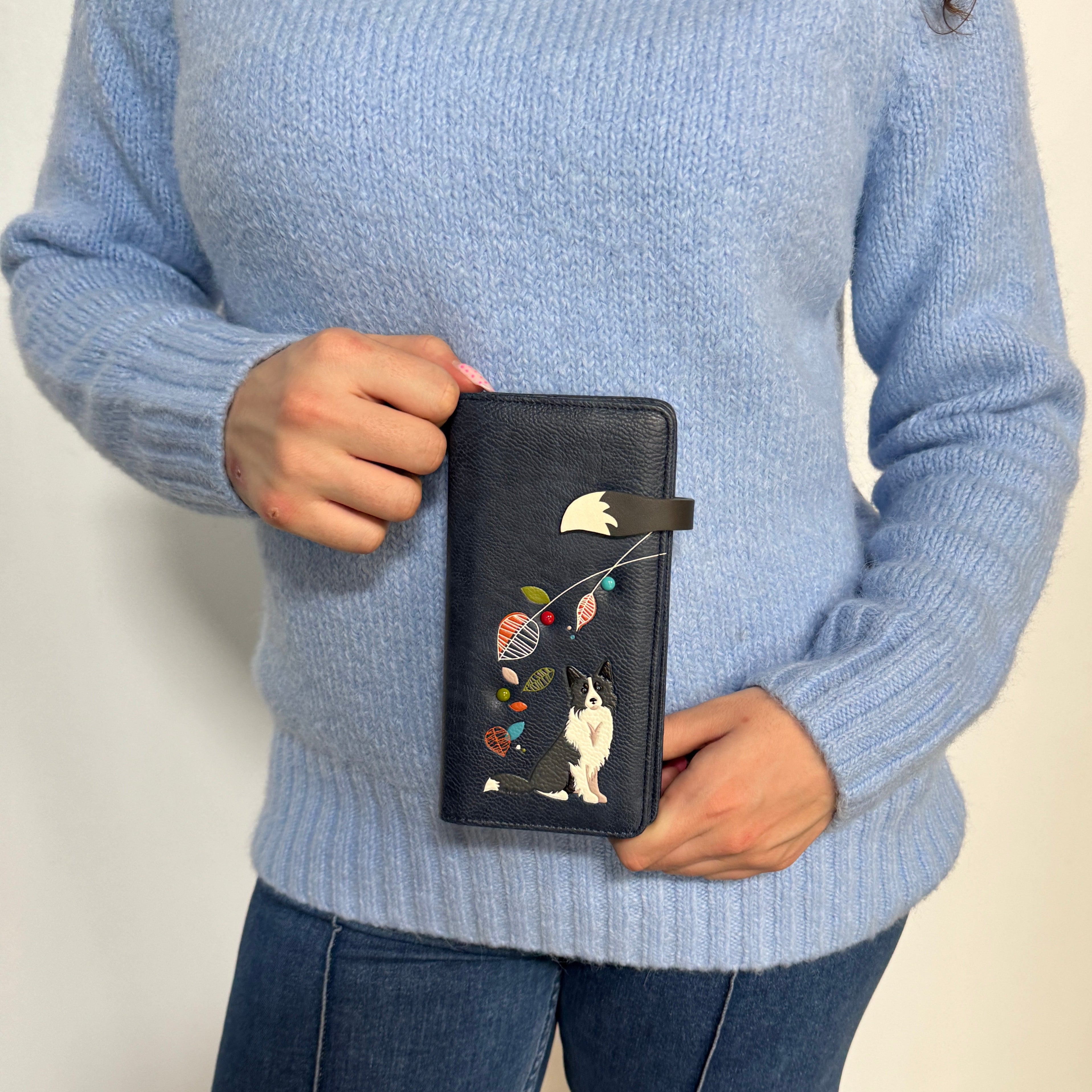 A Espe Vegan Corp black leather wallet featuring a colorful embroidered cat and balloons design.