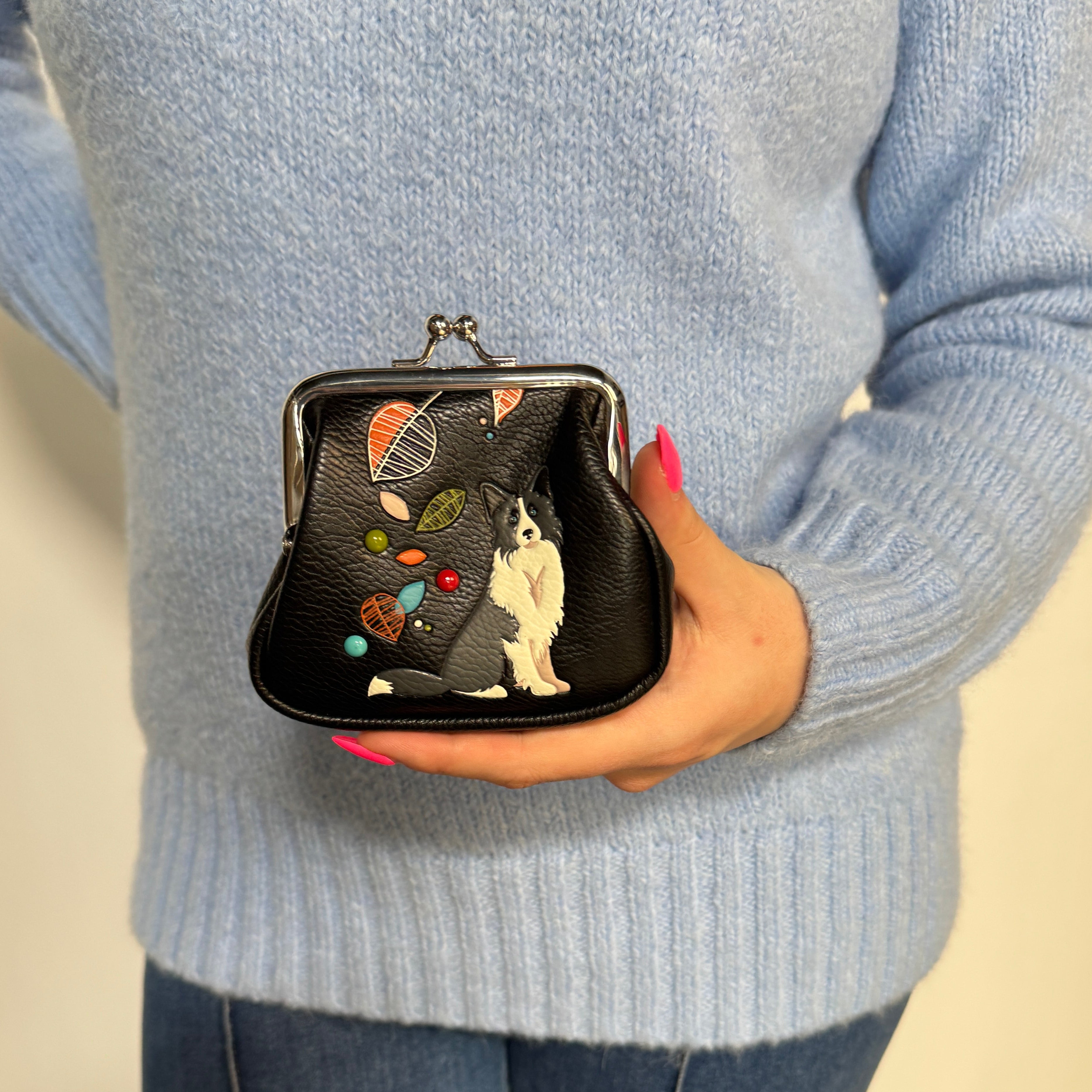 Espe Vegan Corp small black kiss-lock coin purse decorated with a black and white dog illustration and colorful abstract shapes.