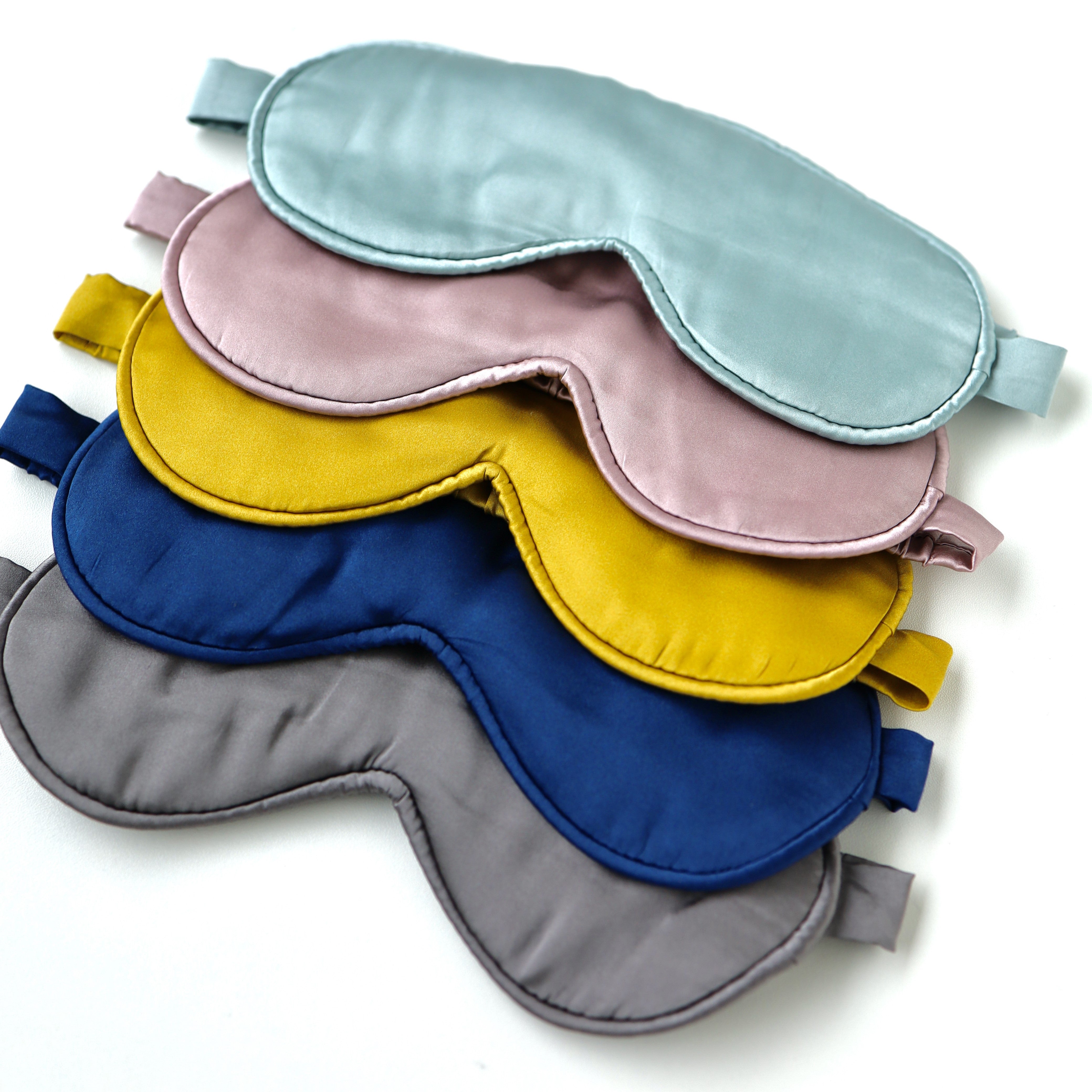 Stack of colorful sleep masks on a white background