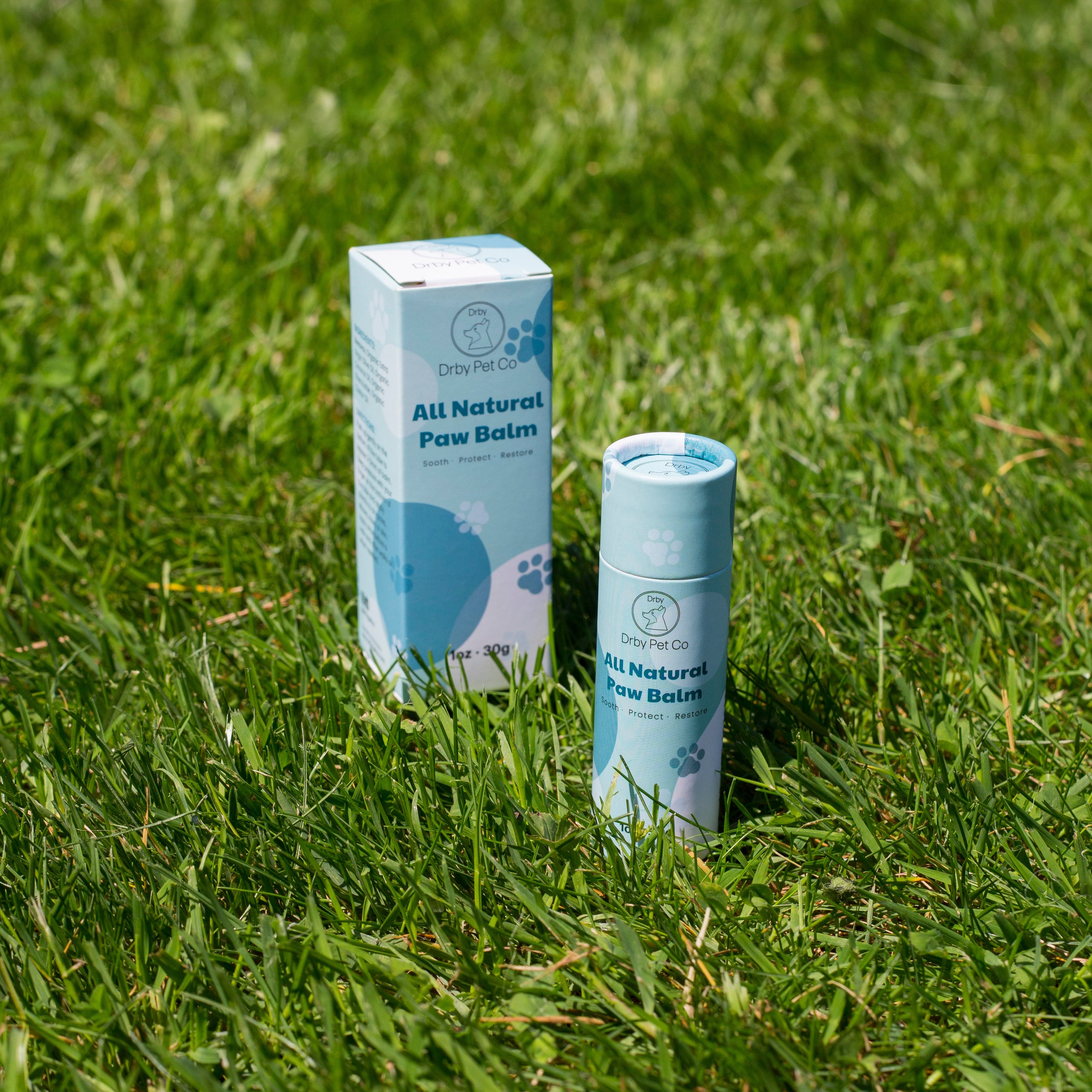 All Natural Paw Balm packaging on grass