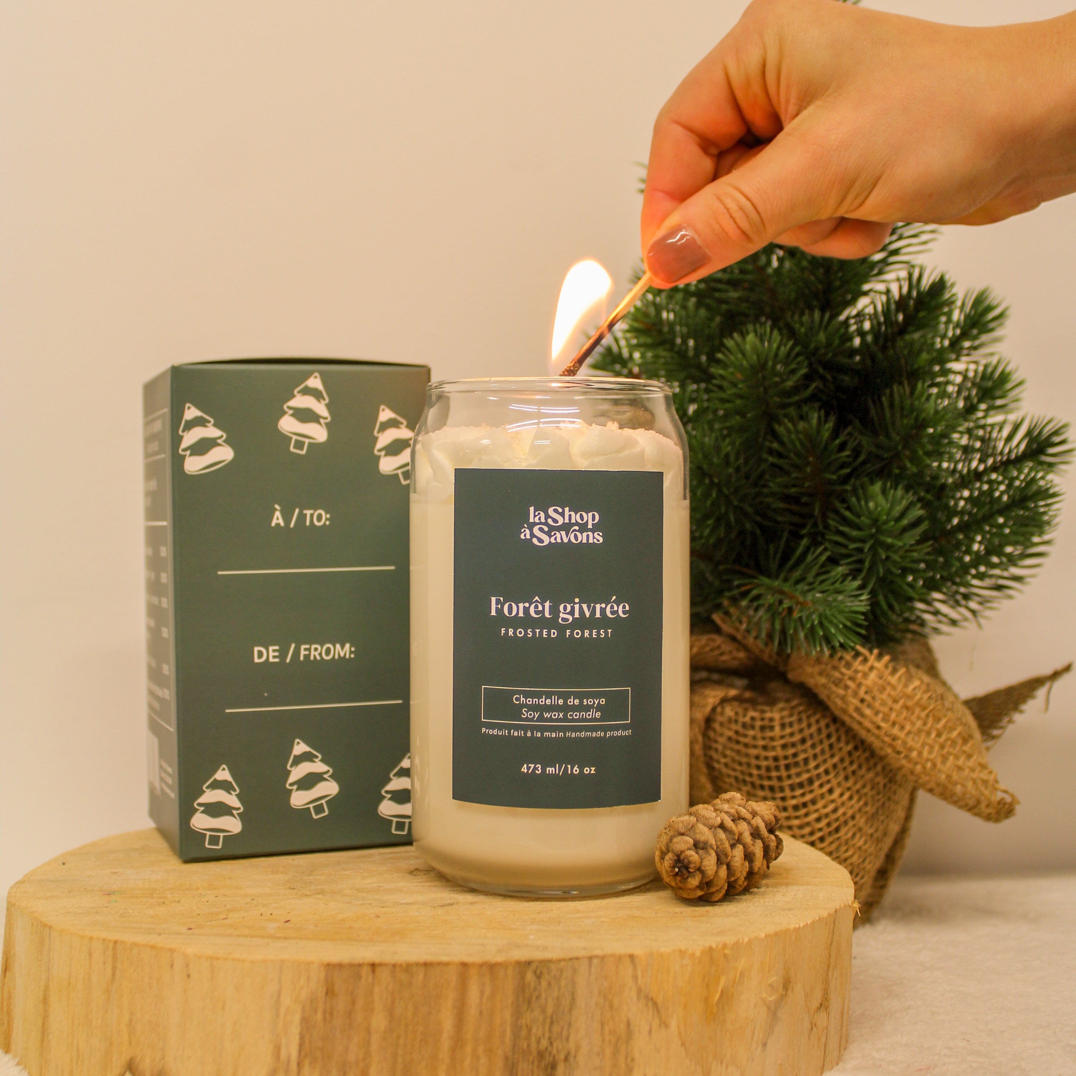Candle being lit with a decorative box and small tree in the background