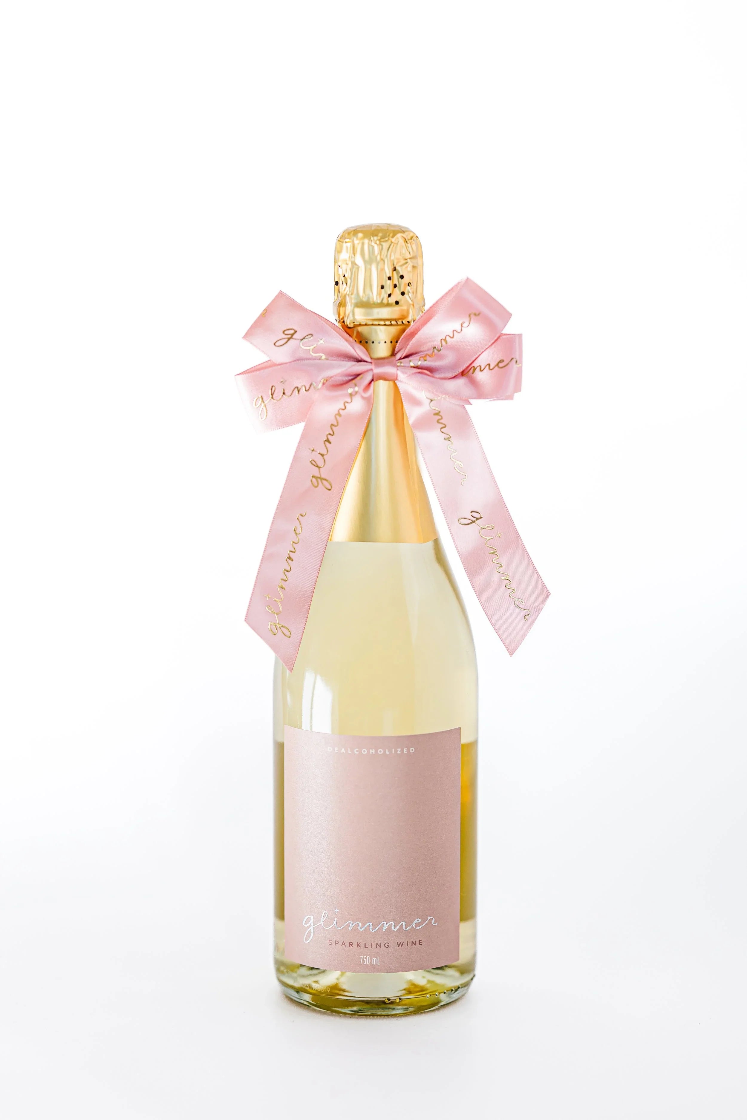Bottle of sparkling wine with a pink ribbon on a white background