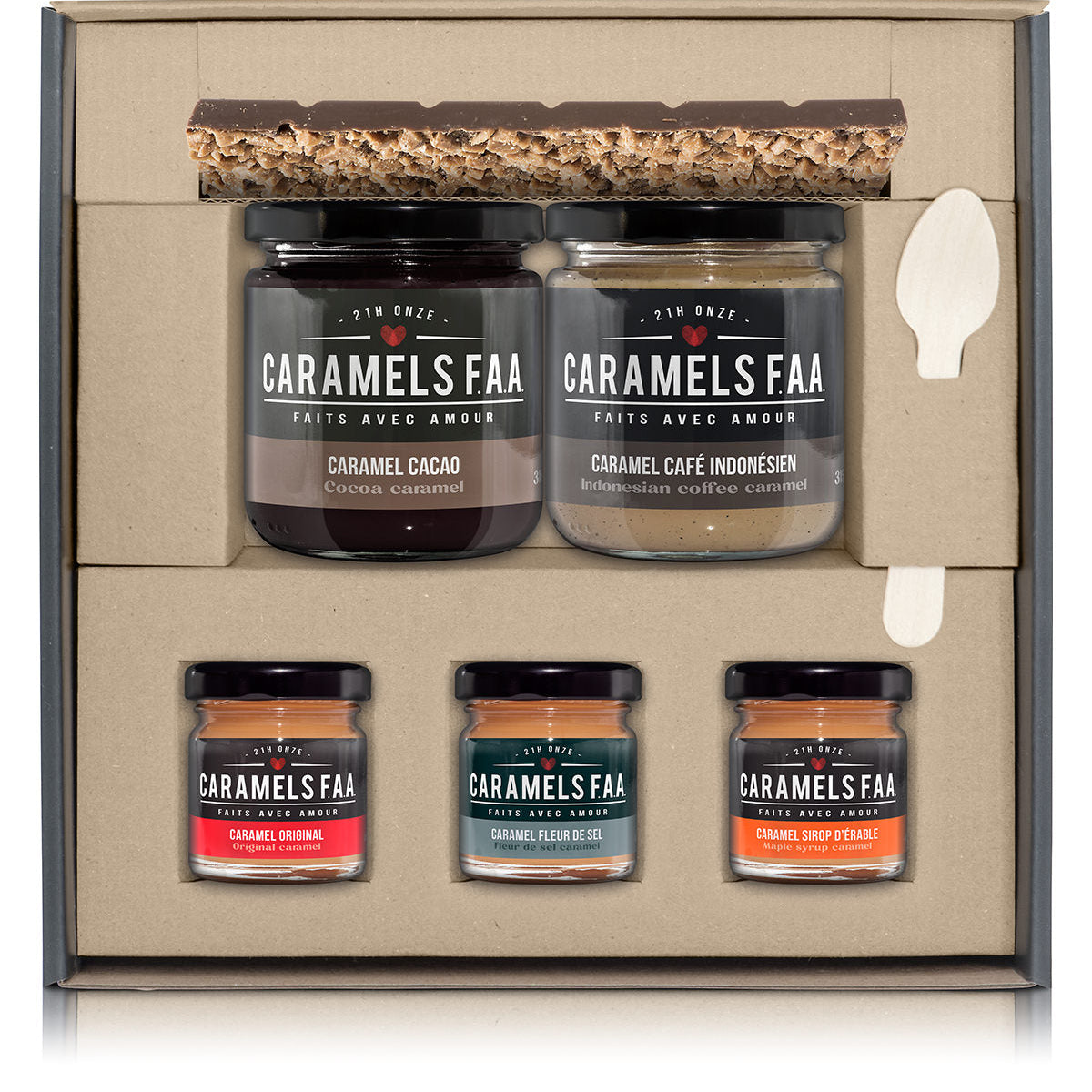 Set of Caramels FAA jars in a decorative box with a spoon on a white background