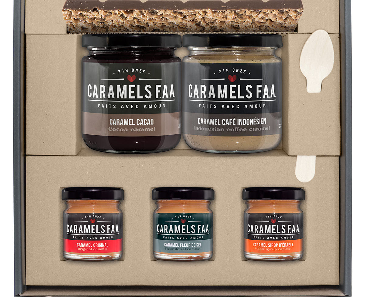Set of Caramels FAA jars in a decorative box with a spoon on a white background
