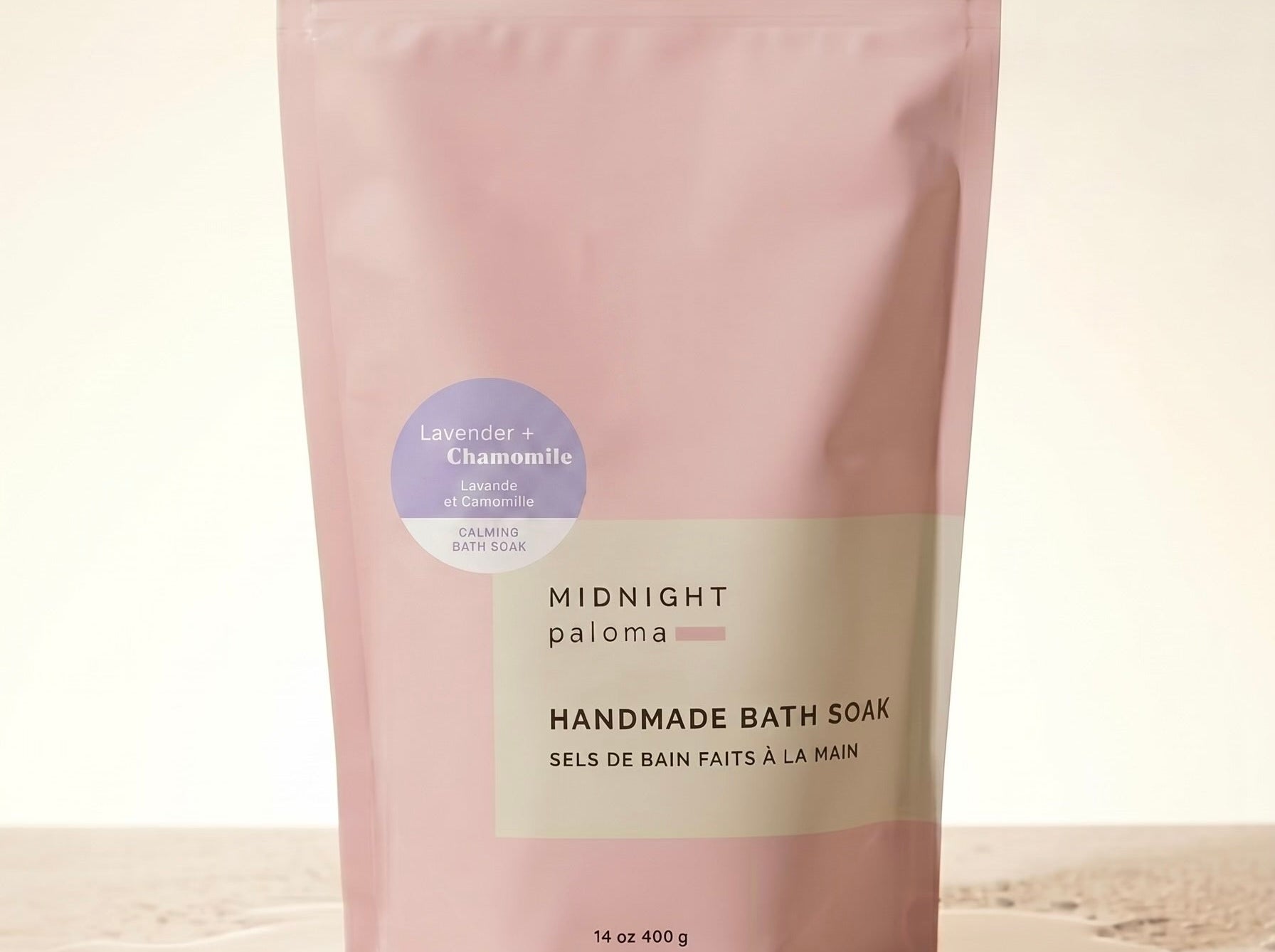 Handmade bath soak packaging with 'Midnight Paloma' branding on a beige background