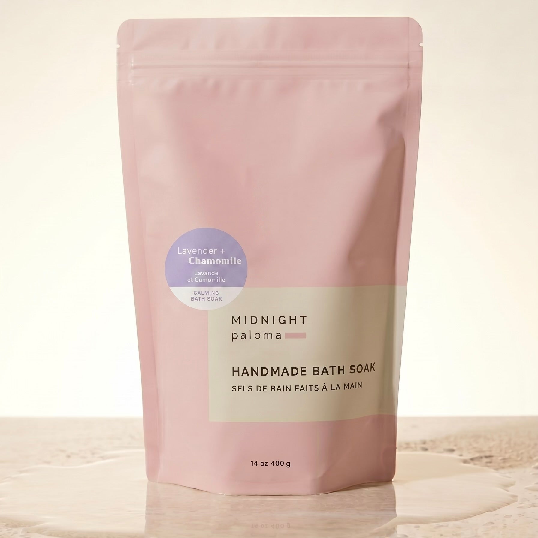 Handmade bath soak packaging with 'Midnight Paloma' branding on a beige background