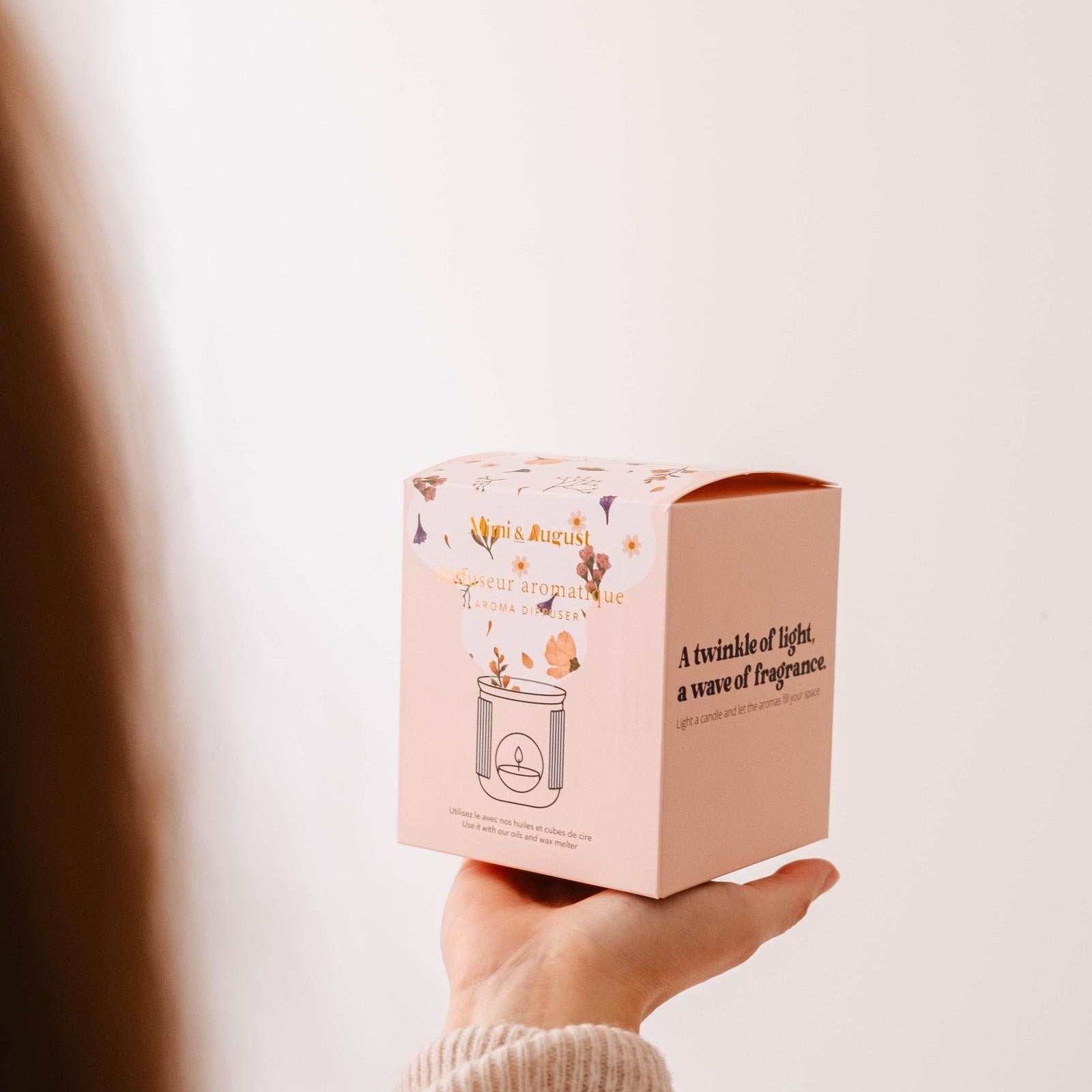 Hand holding a pink box Mimi and August ceramic diffuser