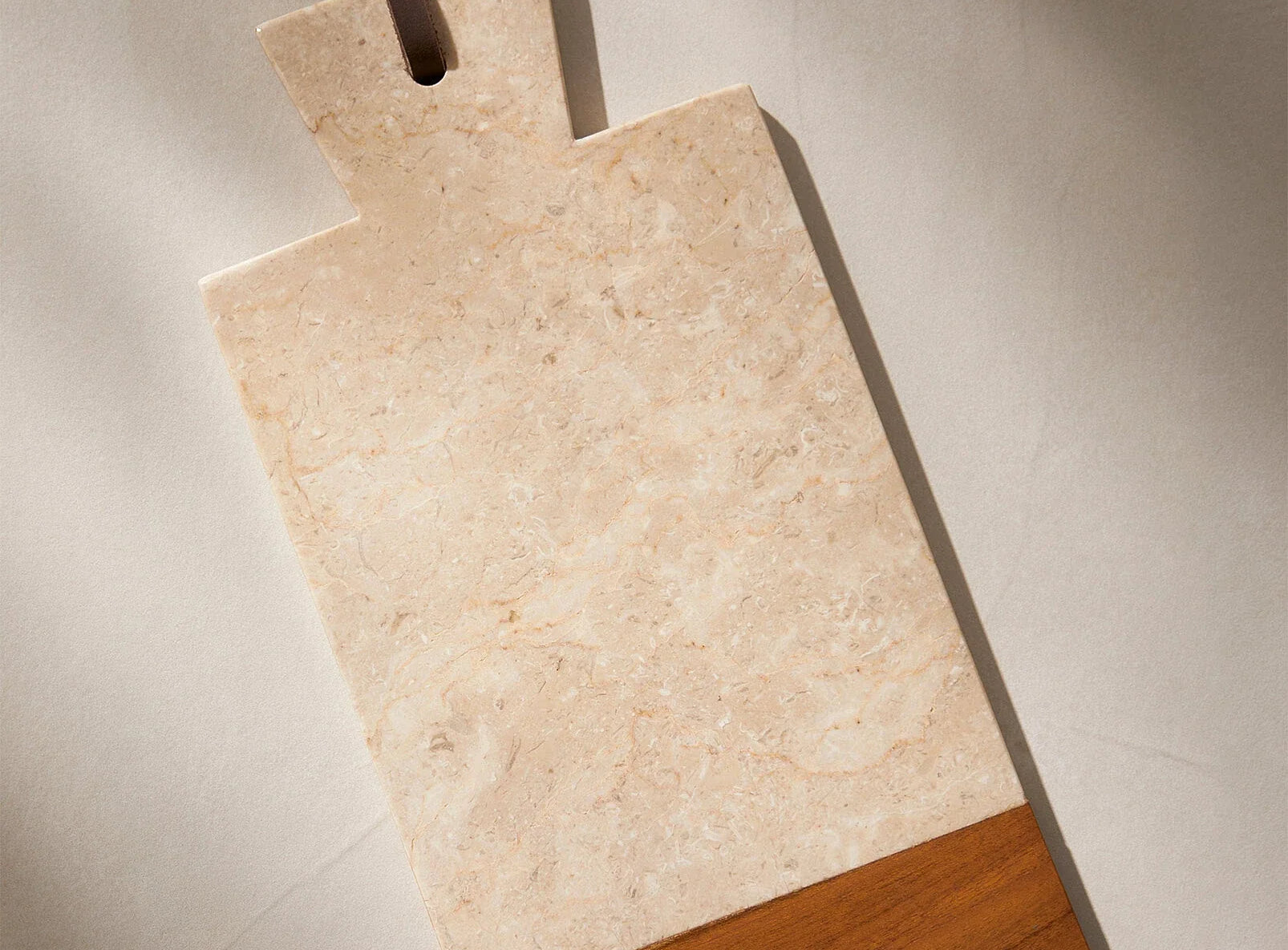 Marble & Teak cutting board on a neutral background