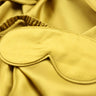 Yellow sleep mask on a yellow fabric background