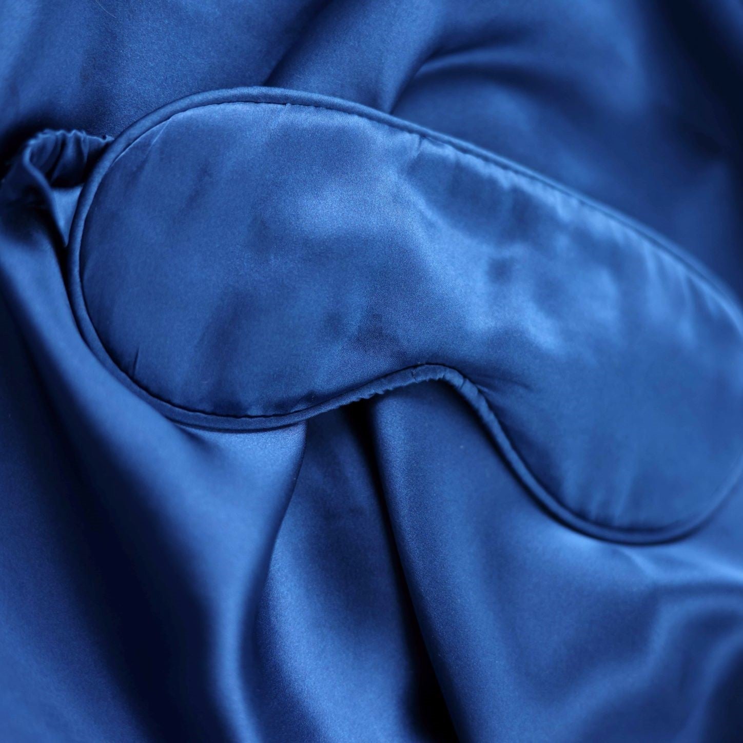 Blue satin eye mask with a smooth texture