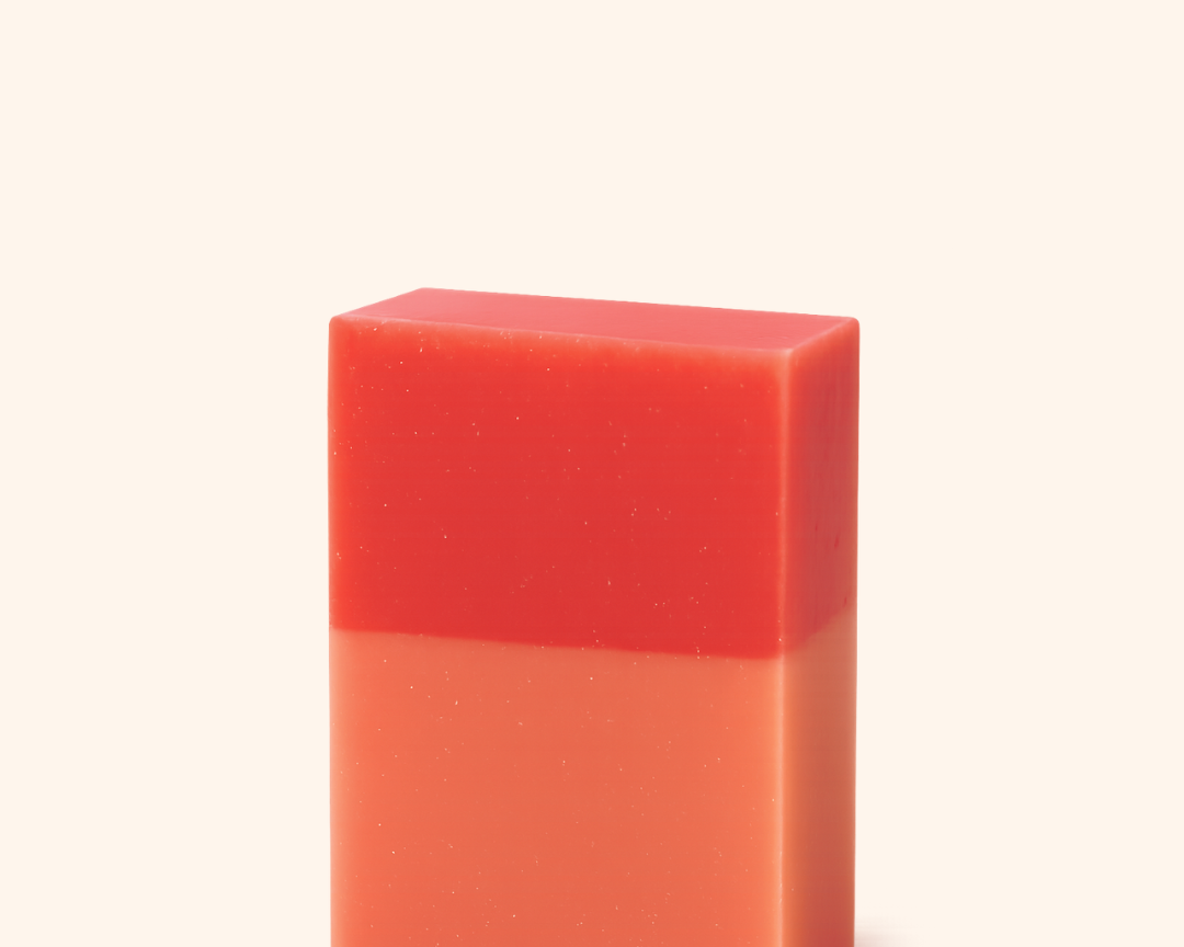 Red and orange gradient bar of soap on a white background