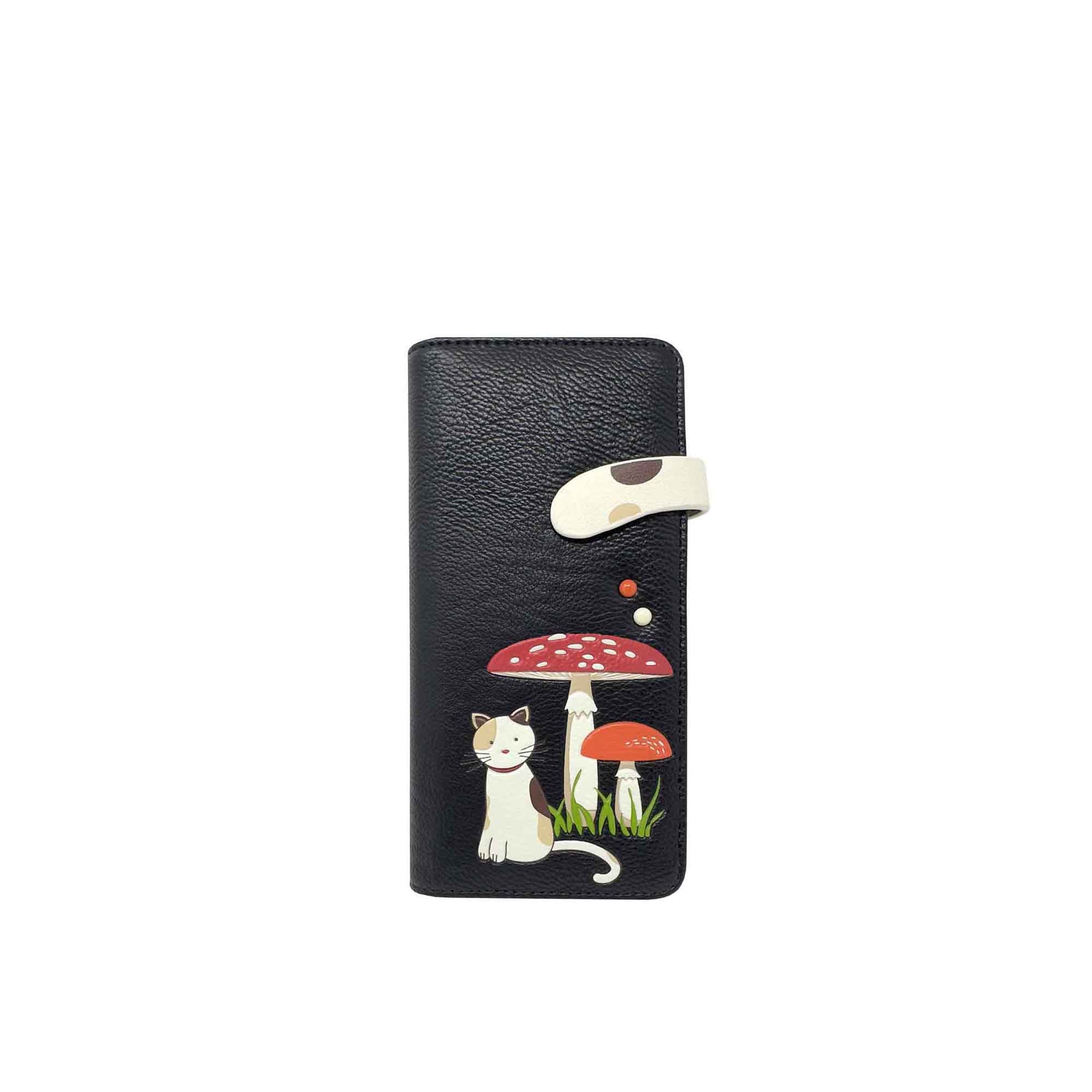 A Espe Vegan Corp black textured leather wallet featuring a whimsical illustration of a white cat under a red and white mushroom on the front, with a cream-colored snap tab closure.
