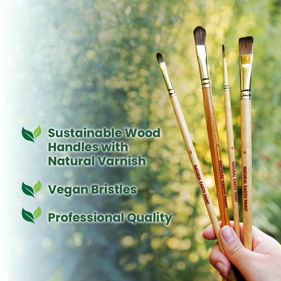 Set of paint brushes with sustainable wood handles and natural varnish, held against a blurred green background.