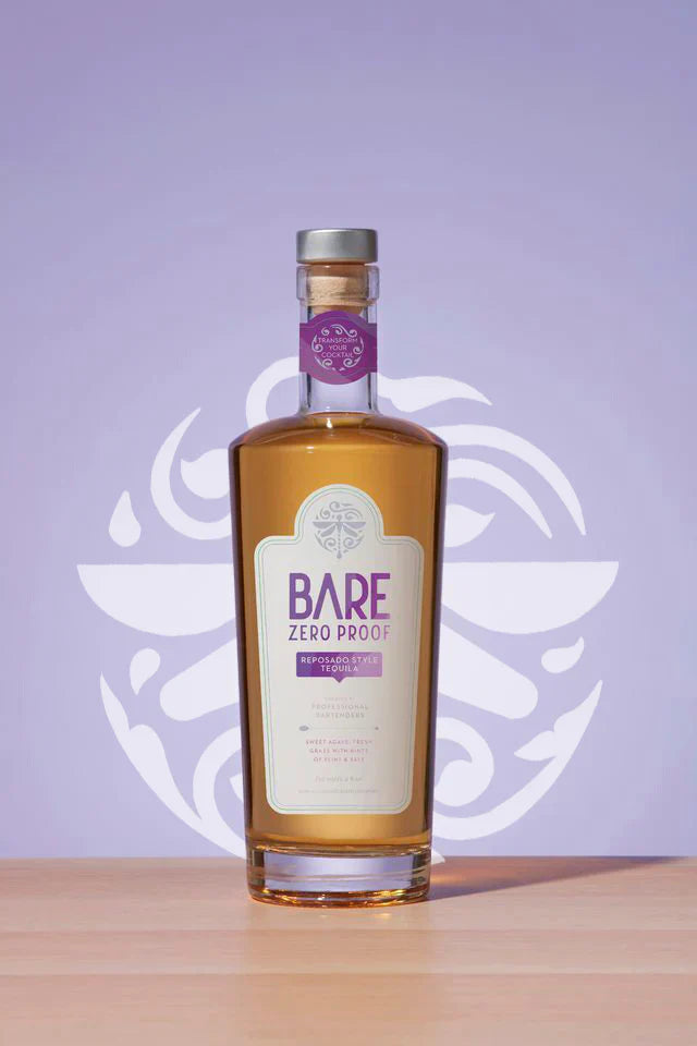 Bottle of Bare Zero Proof on a wooden surface with a purple background