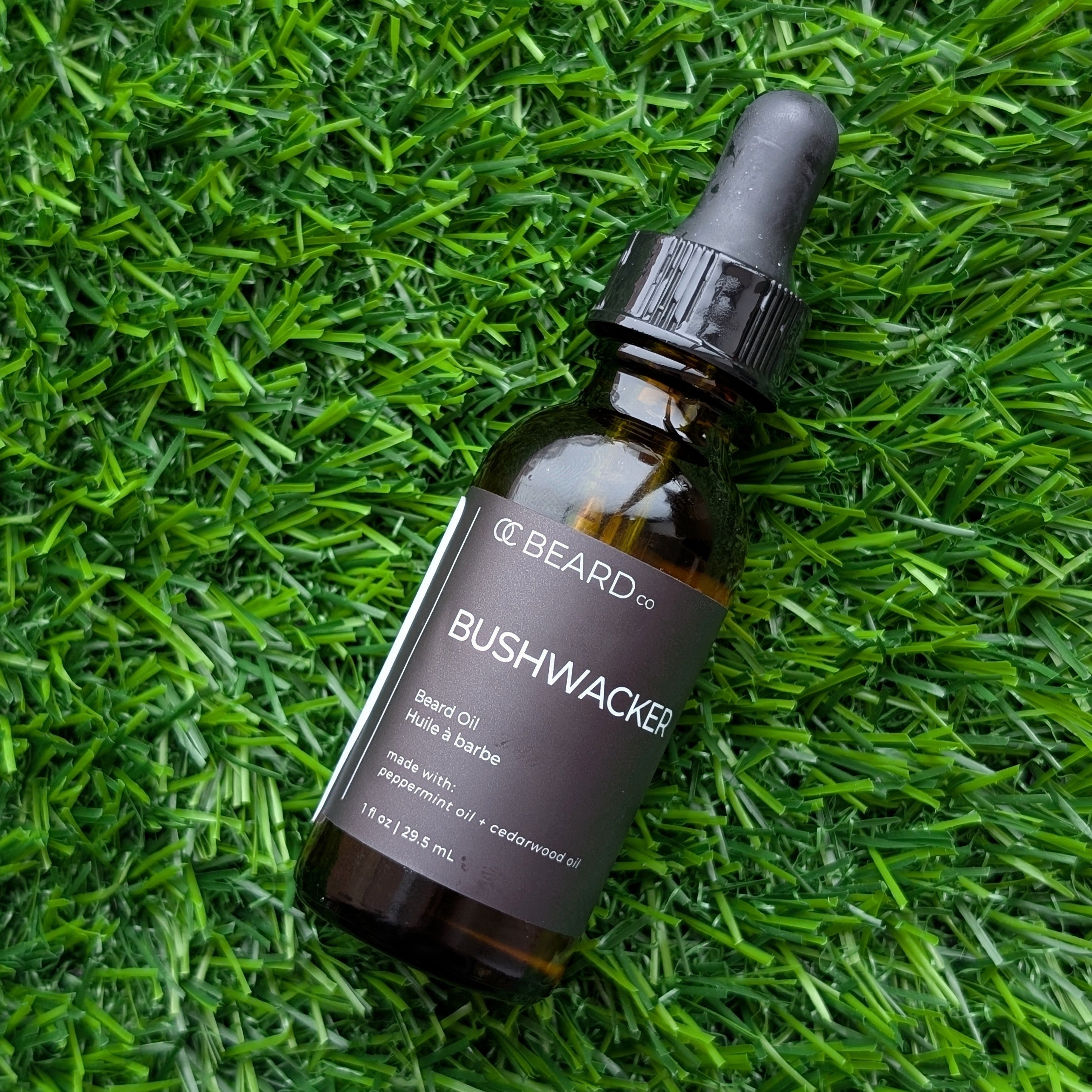 OC Beauty Bottle of Bushwacker beard oil on grass