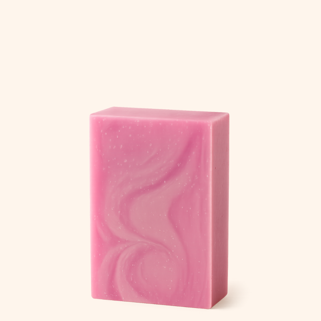 Pink soap bar with wavy pattern on a white background