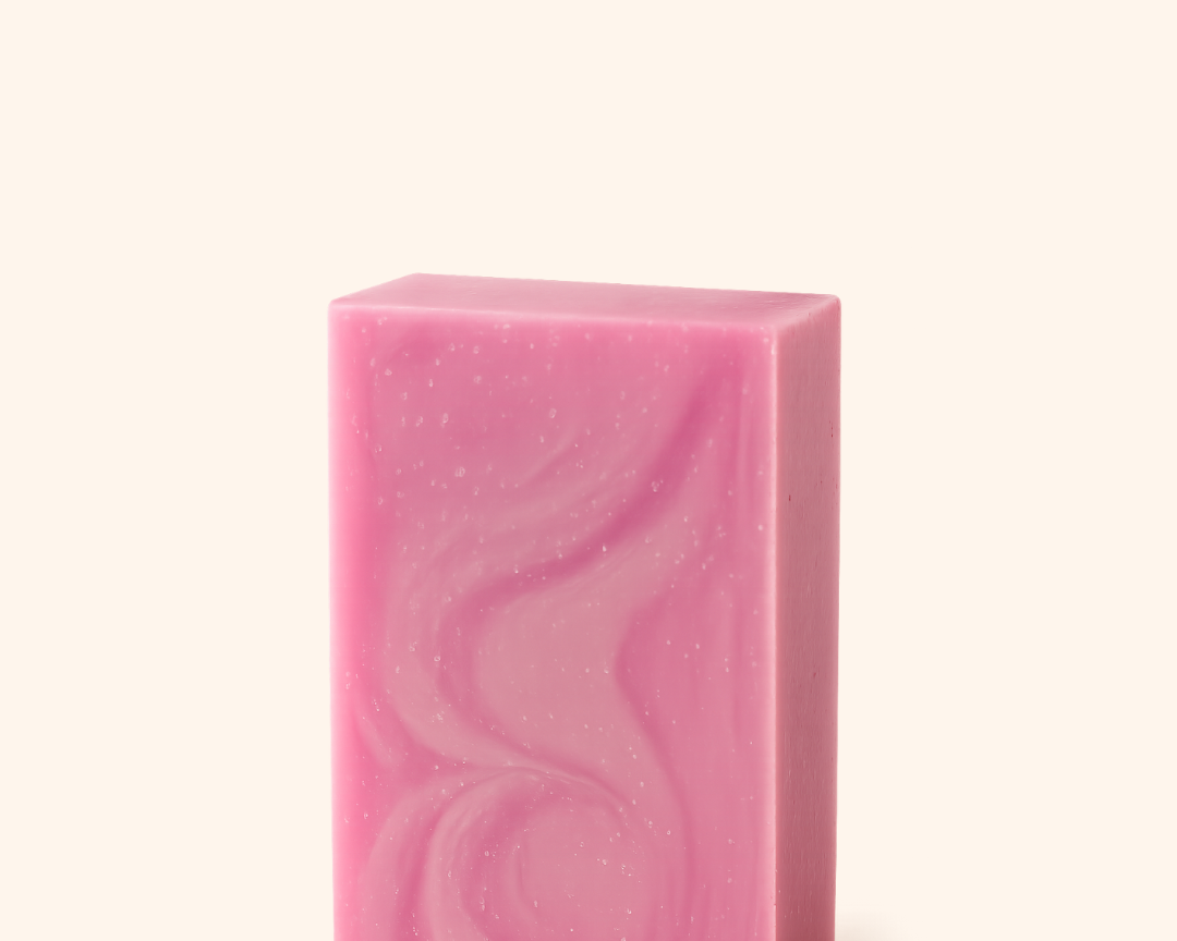 Pink soap bar with wavy pattern on a white background
