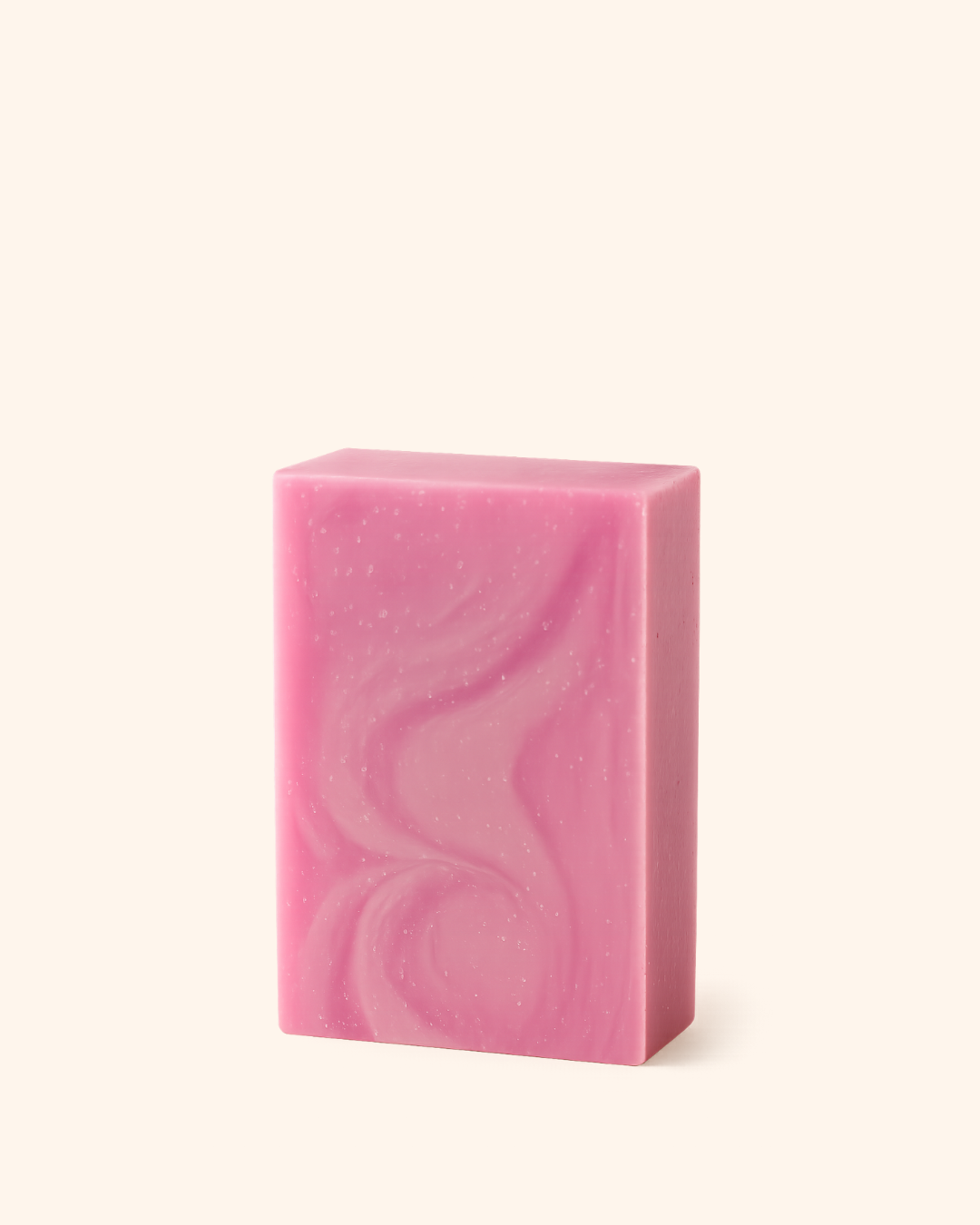 Pink soap bar with wavy pattern on a white background
